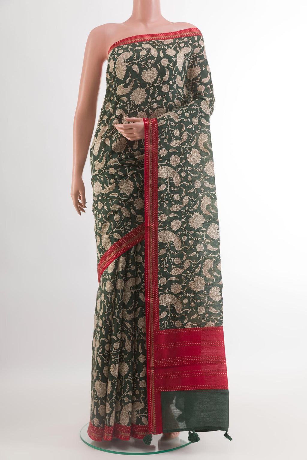 Green Tussar Silk Saree with Printed design on the body and Zari Border.  displayed on a mannequin