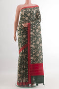 Green Tussar Silk Saree with Printed design on the body and Zari Border.  displayed on a mannequin