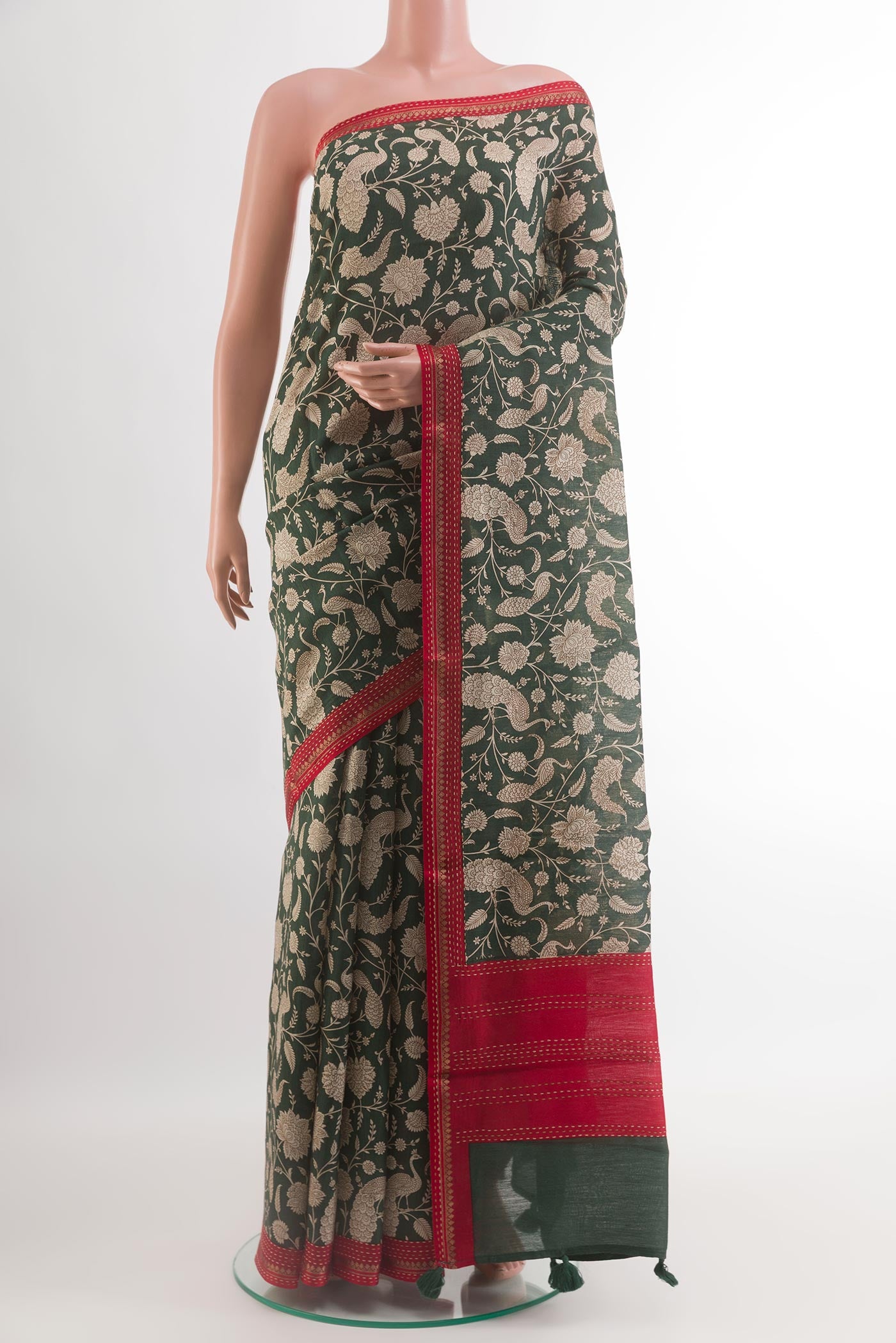 Green Tussar Silk Saree with Printed design on the body and Zari Border.  displayed on a mannequin