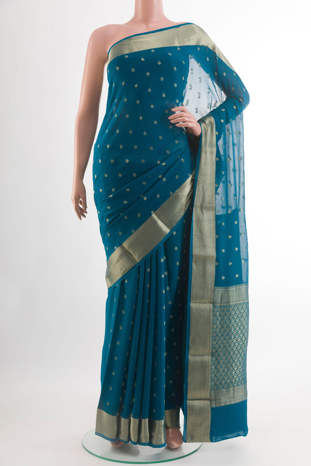 Blue Chiffon Saree with Zari Butta on the body and Zari Border.  displayed on a mannequin