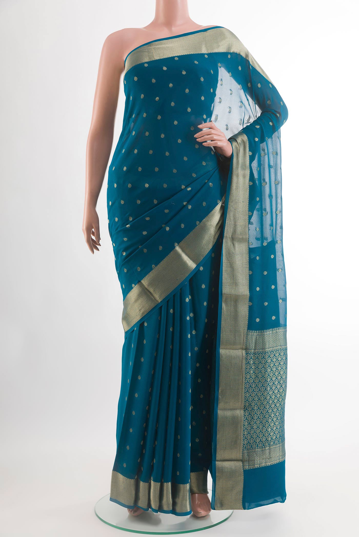 Blue Chiffon Saree with Zari Butta on the body and Zari Border.  displayed on a mannequin