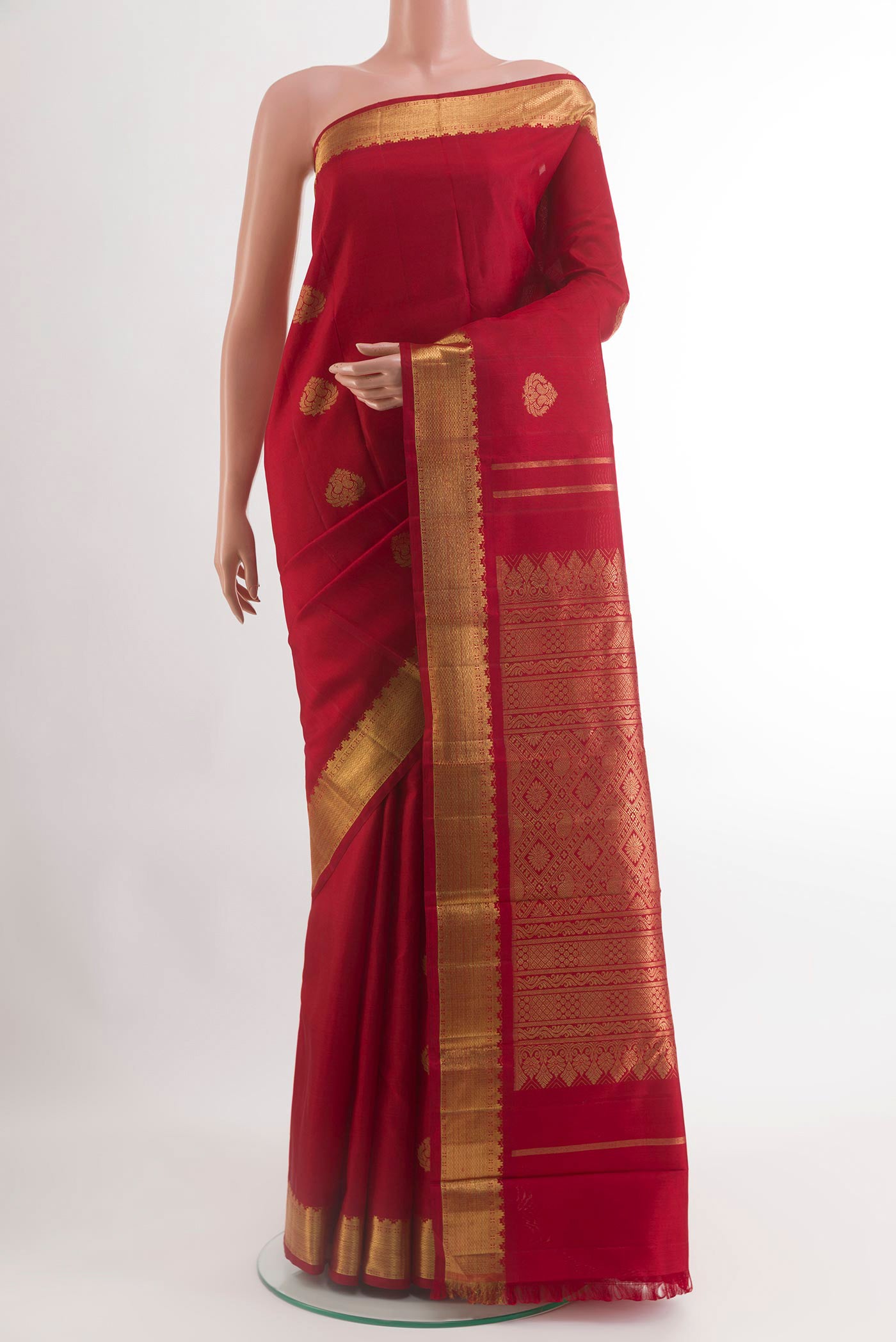 Red Kanchipuram Silk Saree with Zari Butta on the body and Zari Border.  displayed on a mannequin