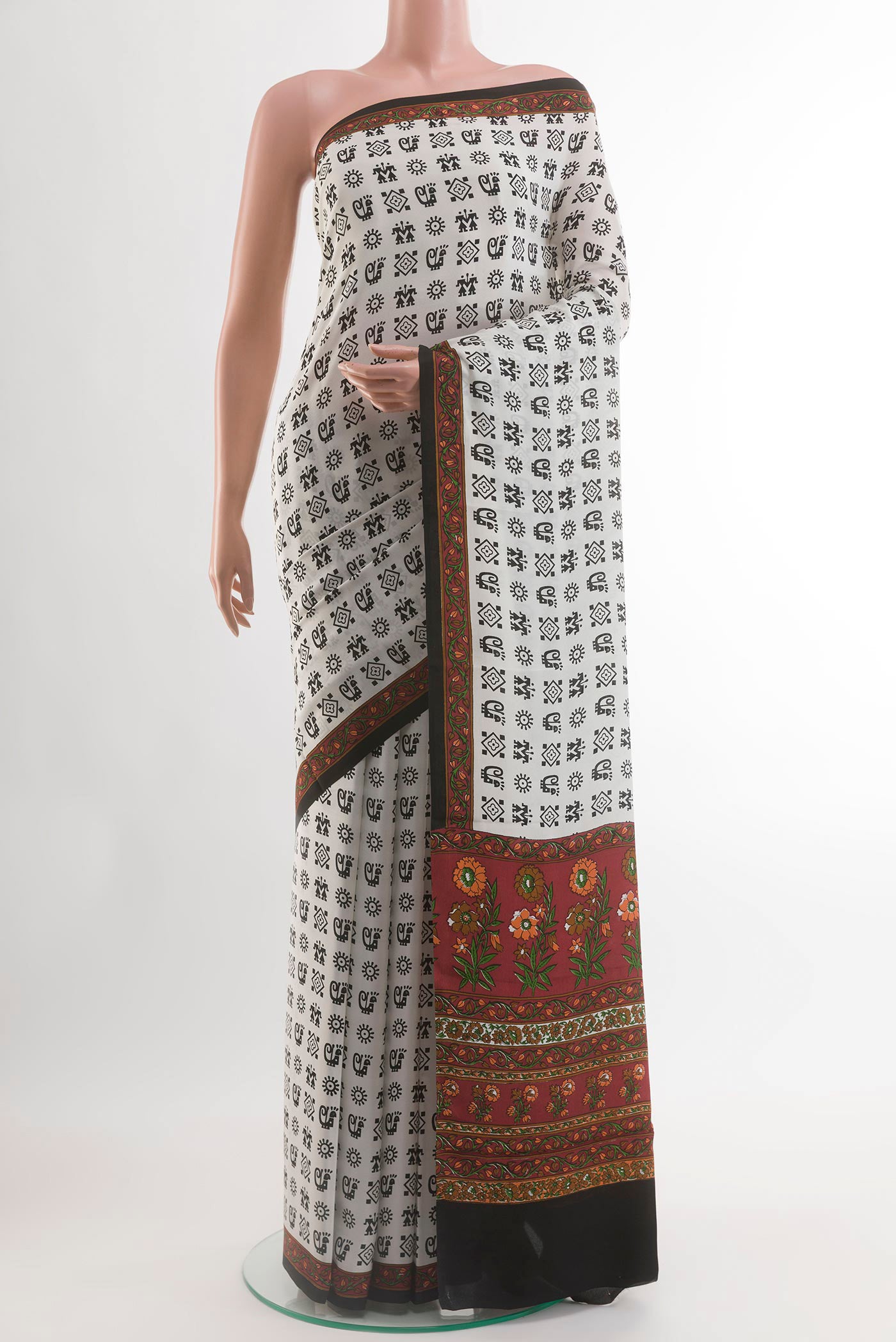 White Crepe Saree with Printed design on the body and Printed Border.  displayed on a mannequin