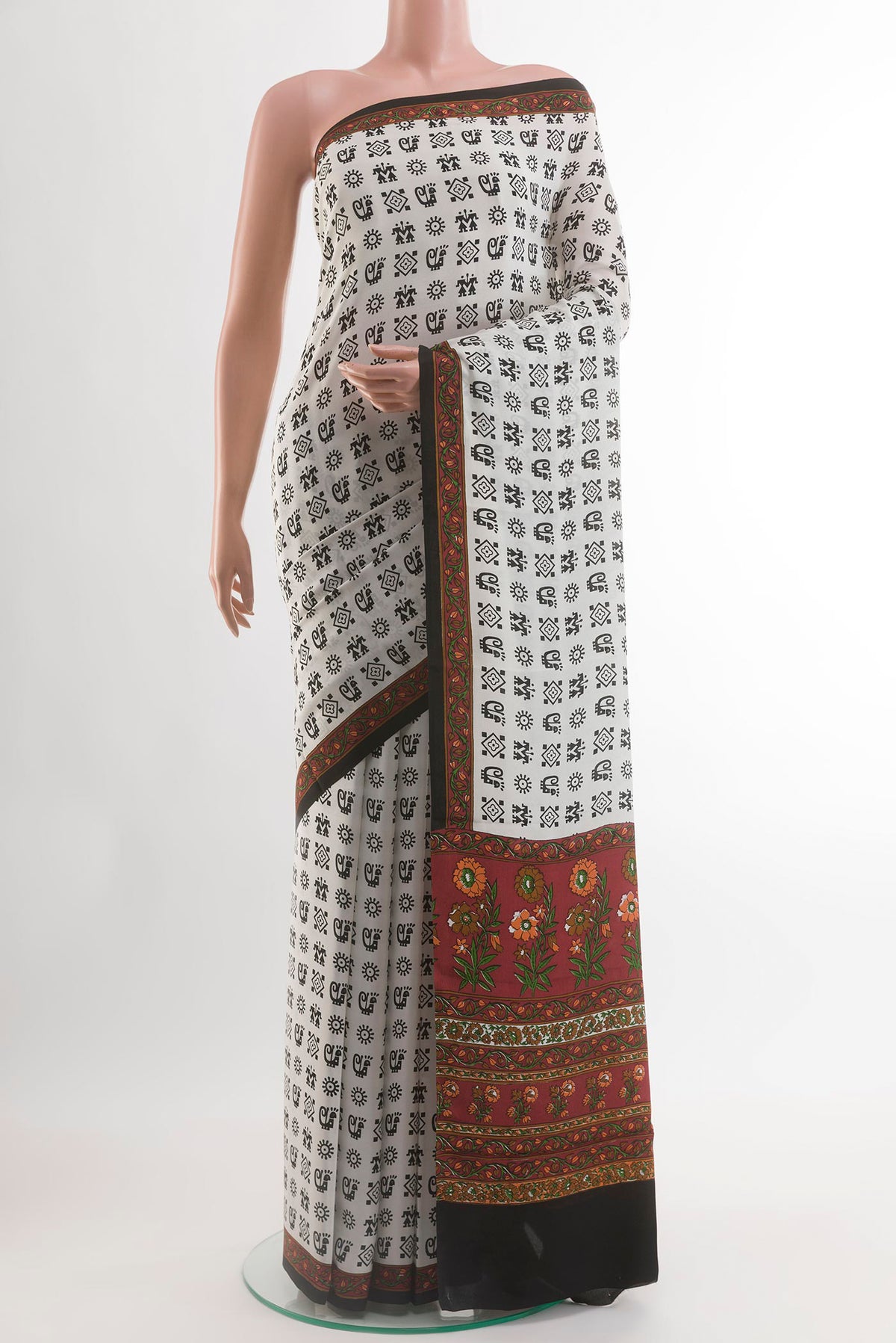 White Crepe Saree with Printed design on the body and Printed Border.  displayed on a mannequin