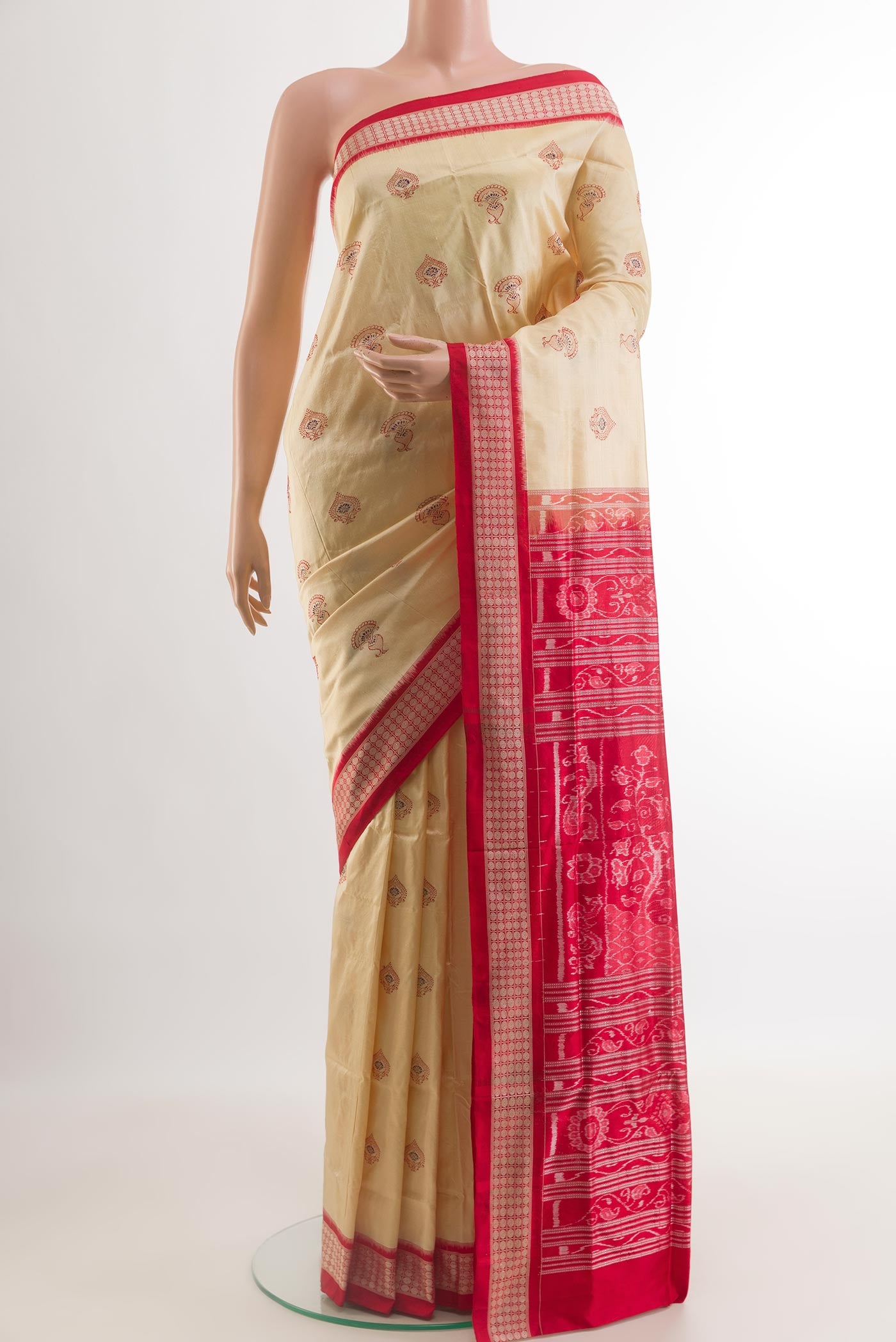 Cream Orissa Silk Saree with Thread Butta on the body and Ikat Border.  displayed on a mannequin