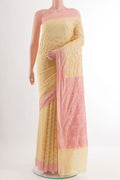 Cream Banarasi Georgette Saree with Zari Brocade on the body and Zari Border.  displayed on a mannequin