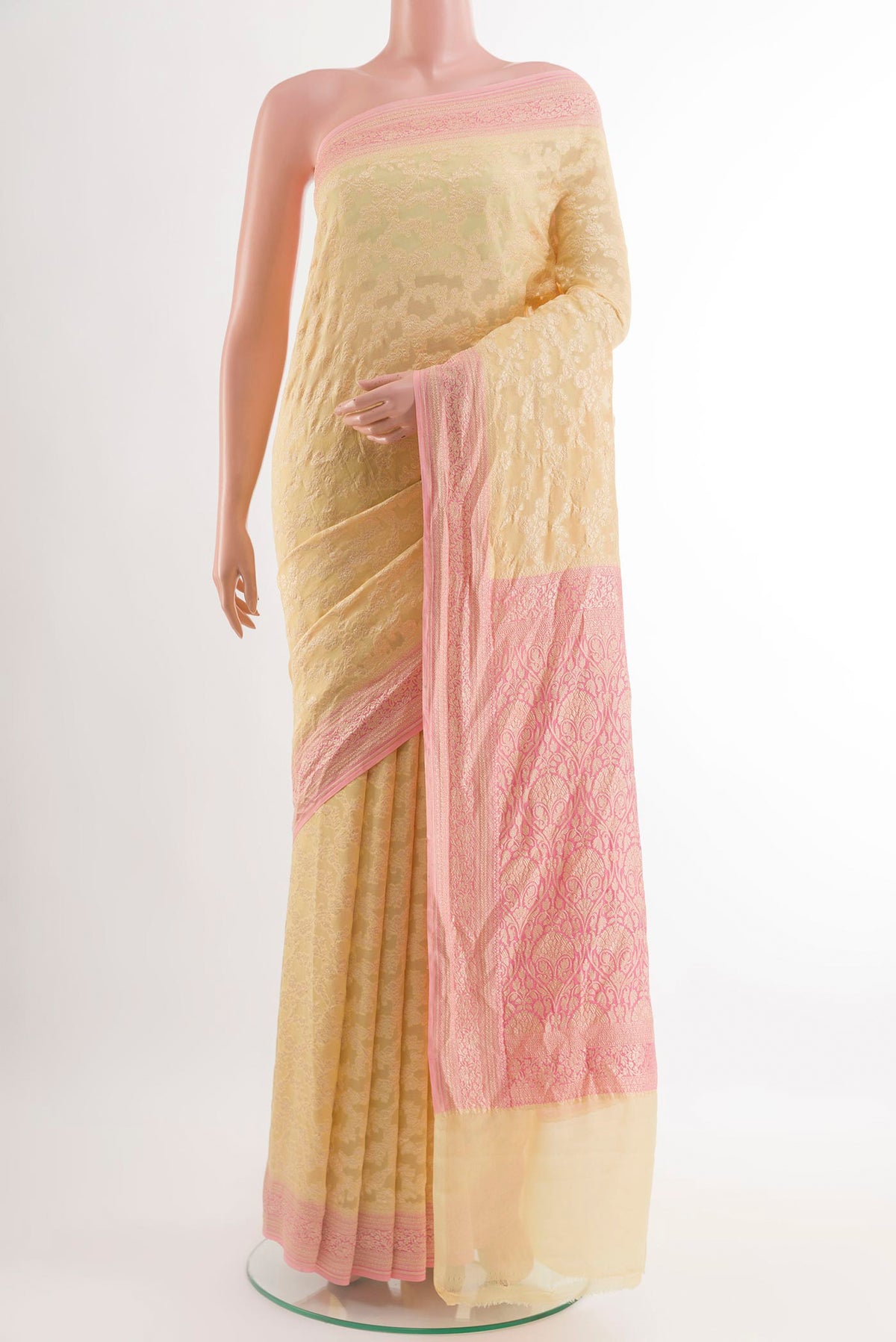 Cream Banarasi Georgette Saree with Zari Brocade on the body and Zari Border.  displayed on a mannequin