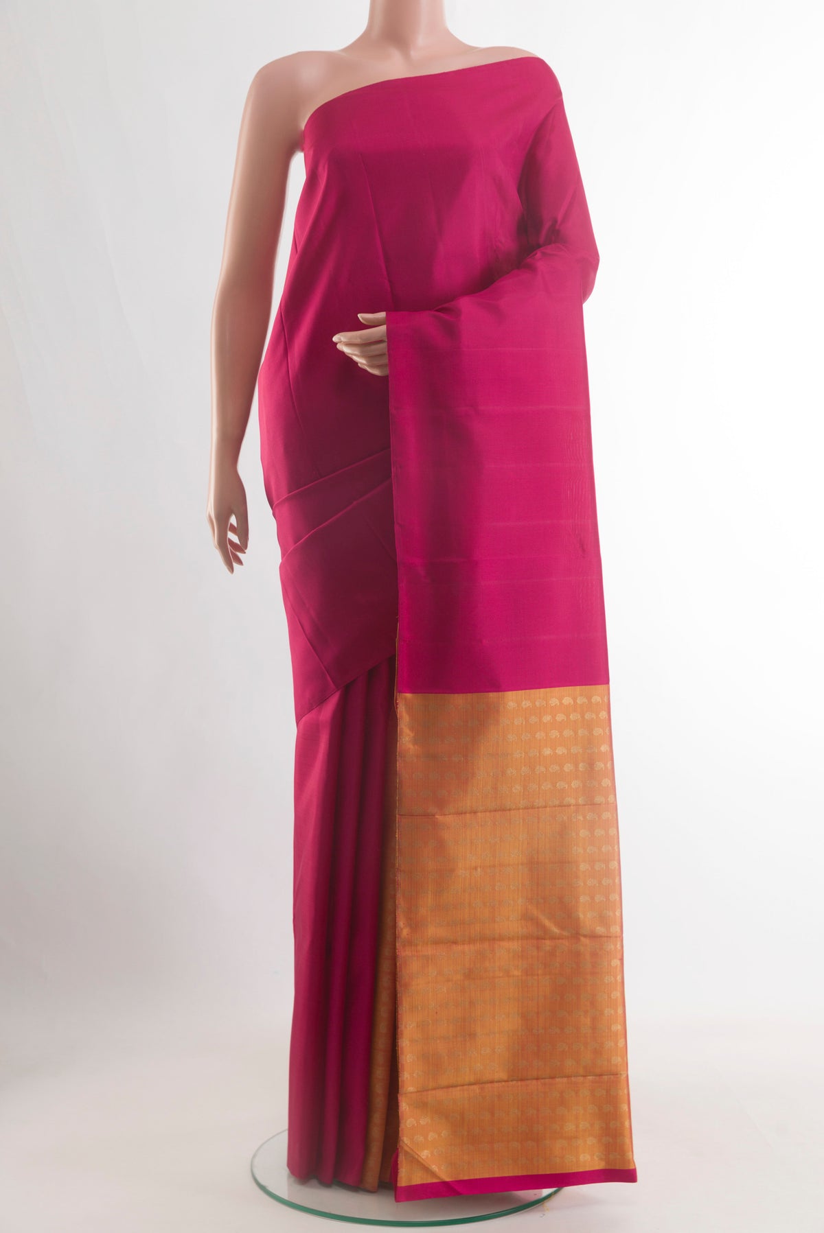 Magenta Kanjivaram Silk Saree with Plain Body and Without Border.  displayed on a mannequin