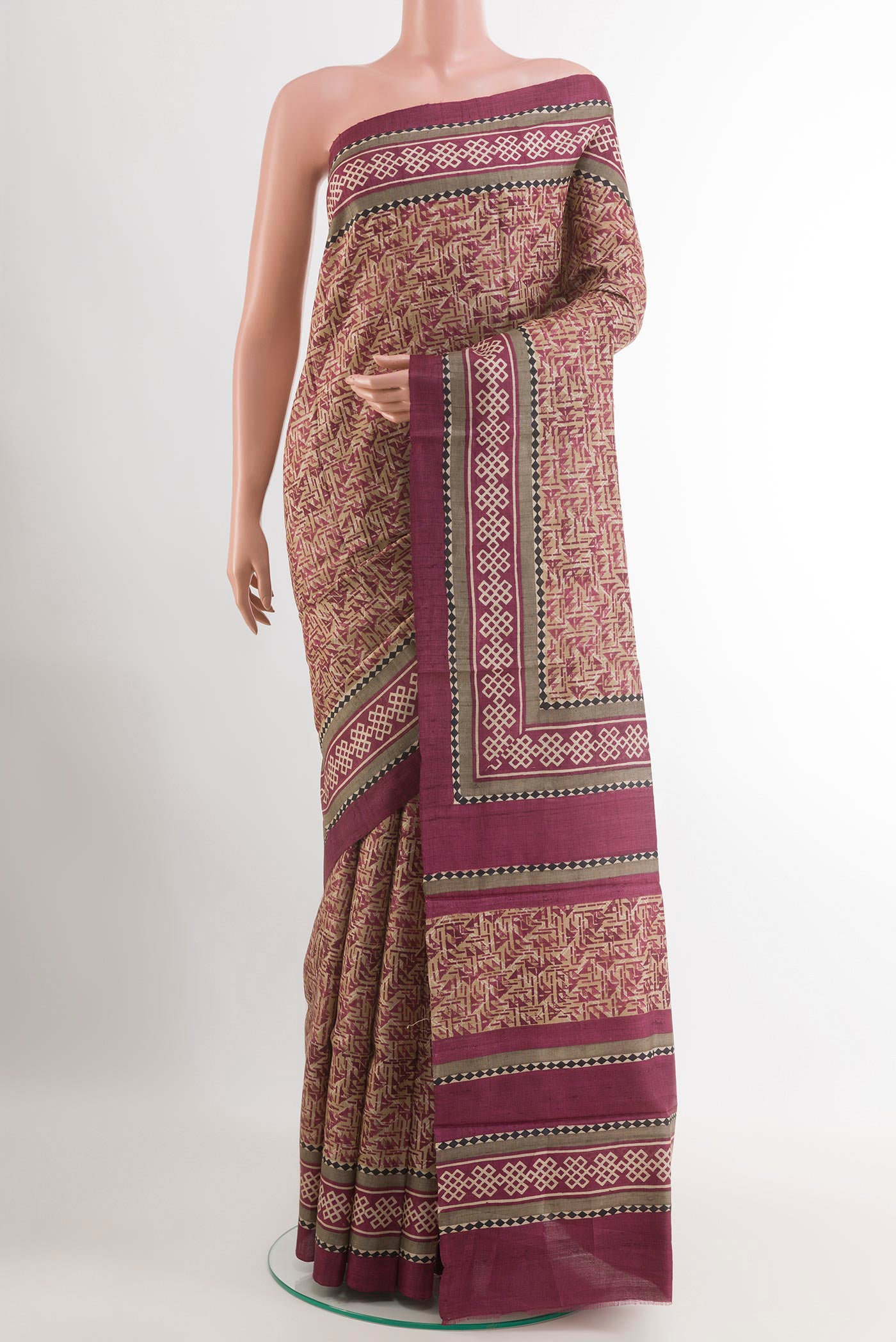 Beige Tussar Saree with Printed design on the body and Plain Border.  displayed on a mannequin
