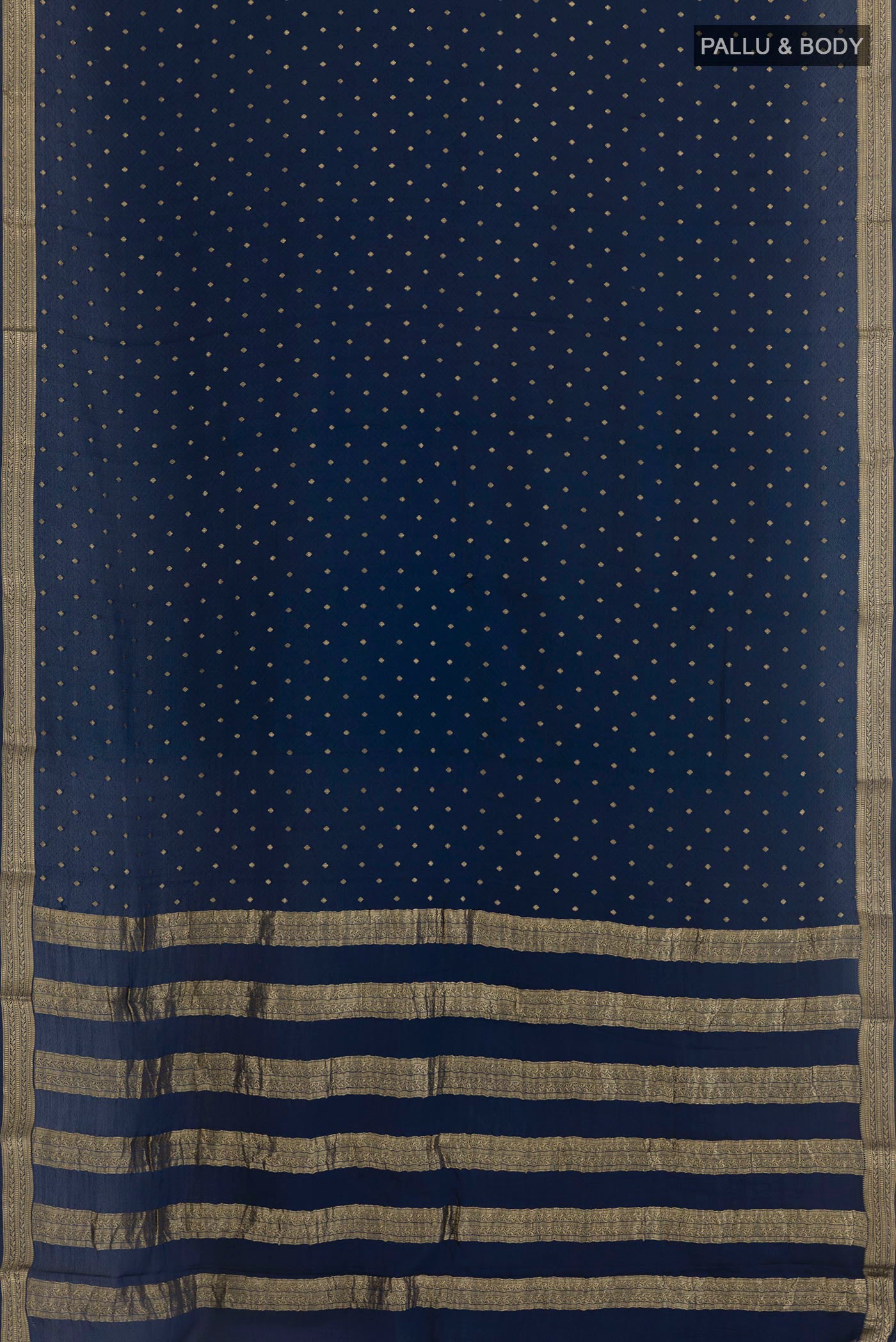 Flat view of Navy Blue Mysore Crepe Saree with Zari Butta on the body and Zari Border. 