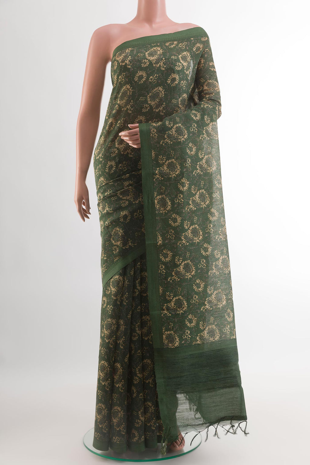 Bottle Green Tussar Silk Saree with Printed design on the body and Thread Border.  displayed on a mannequin