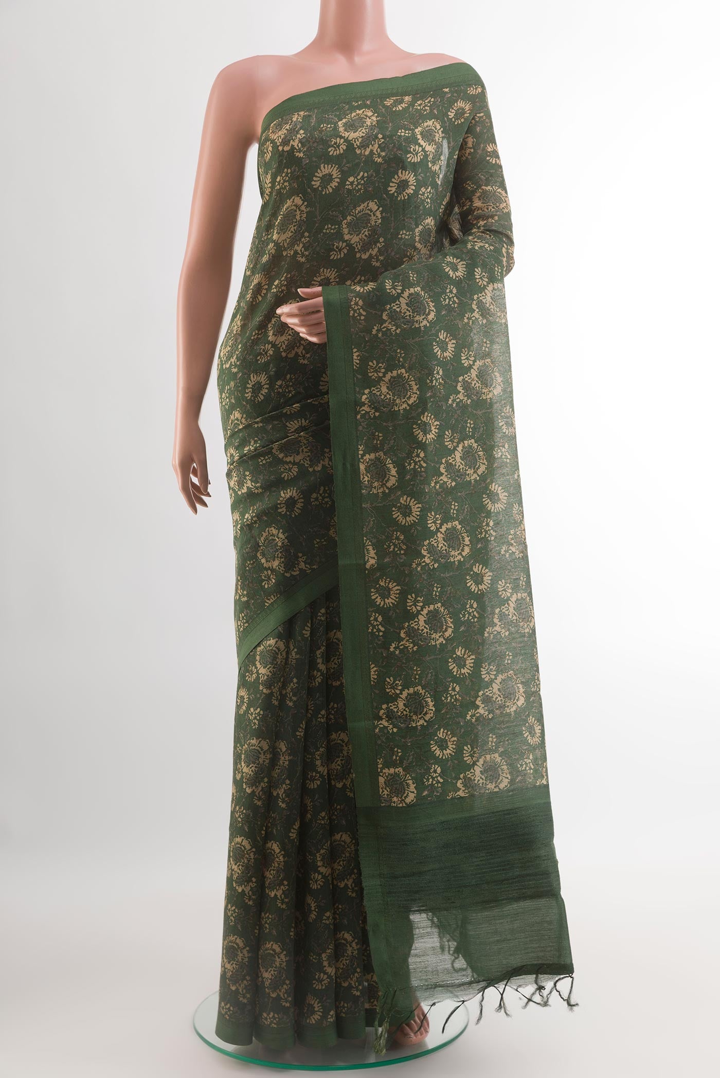 Bottle Green Tussar Silk Saree with Printed design on the body and Thread Border.  displayed on a mannequin