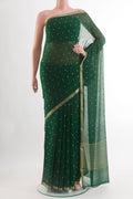 Green Chiffon Saree with Zari Butta on the body and Zari Border.  displayed on a mannequin