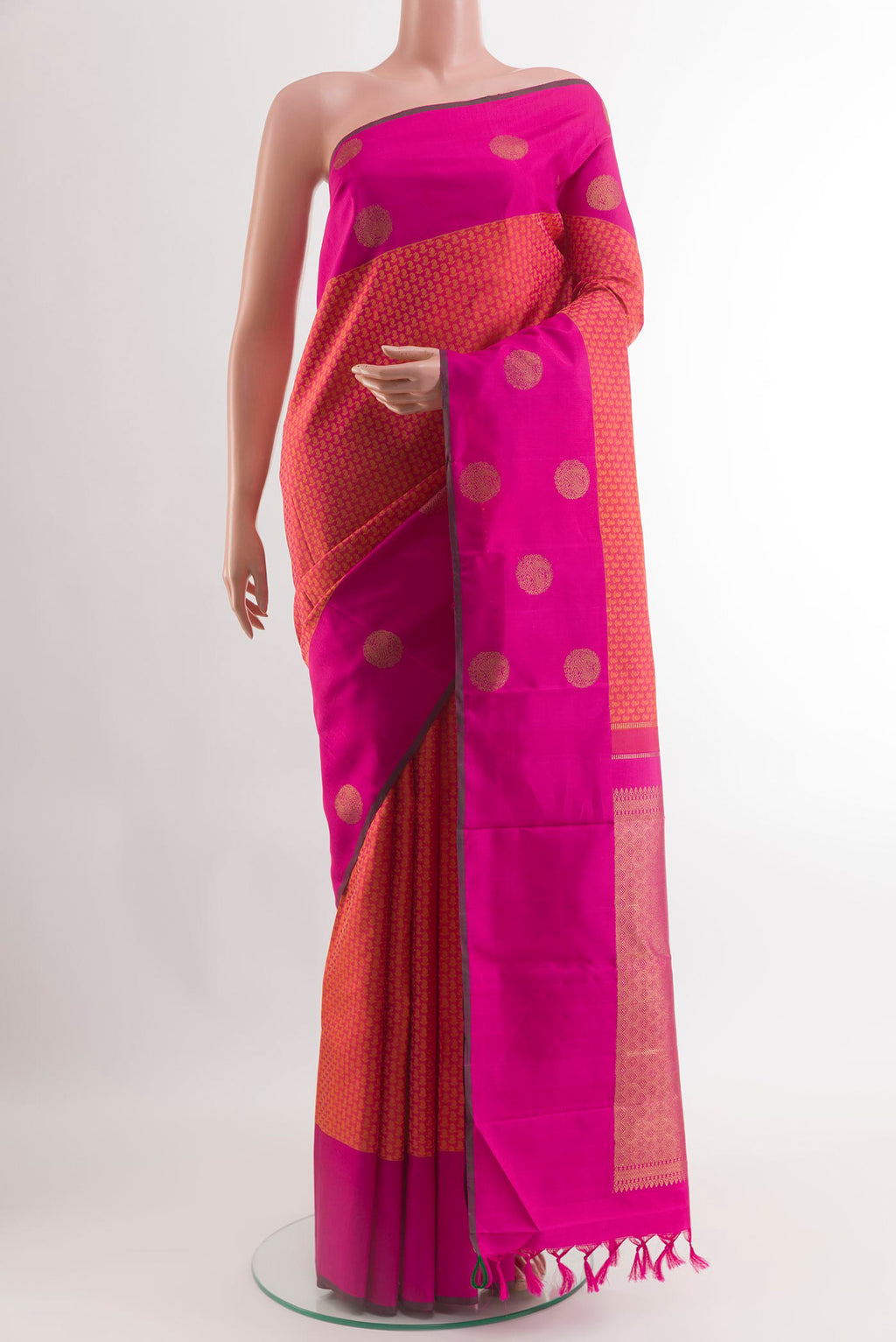 Brick Orange Kanjivaram Silk Saree with Jacquard design on the body and Plain Border.  displayed on a mannequin