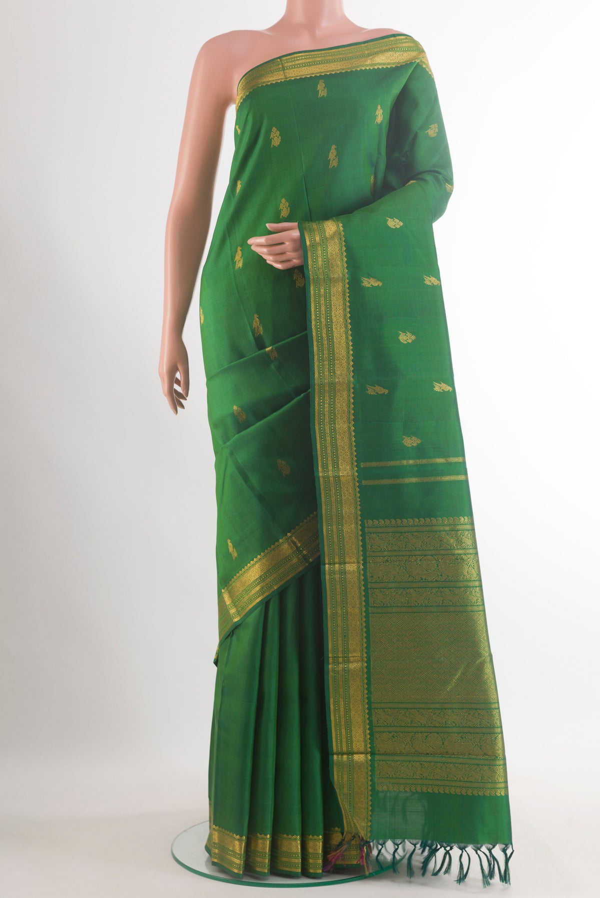 Pure Silk Green Kanchipuram Saree with Zari Butta on the body and Zari Border.  displayed on a mannequin