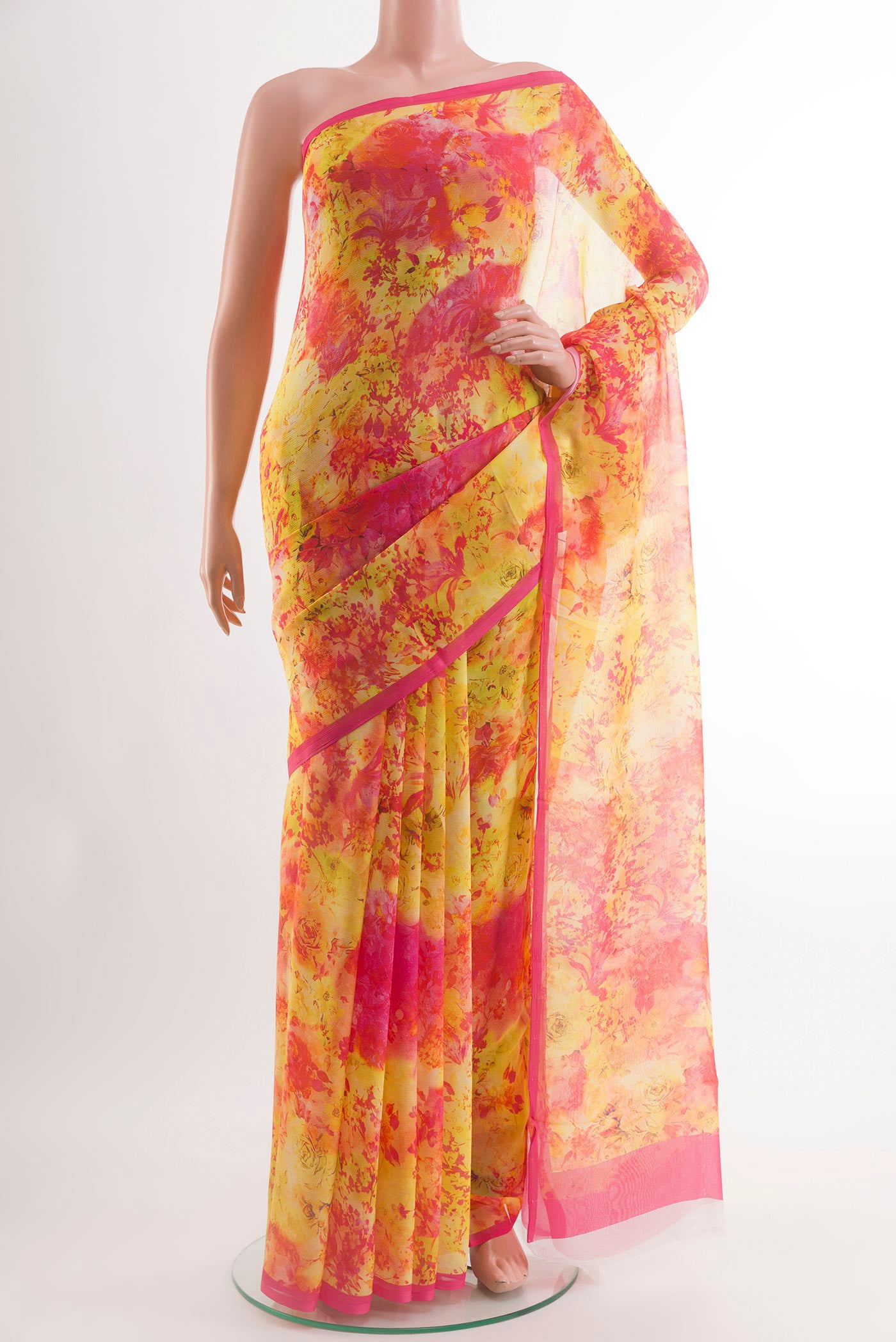 Yellow Chiffon Saree with Printed design on the body and Zari Border.  displayed on a mannequin