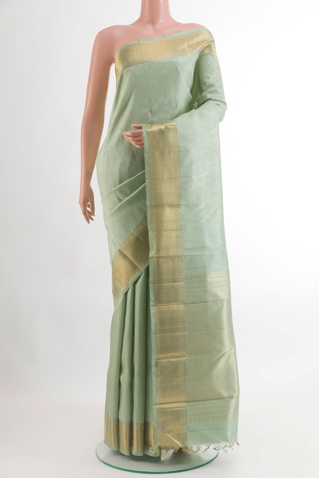 Mint Green Kanchipuram Silk Saree with Jacquard design on the body and Zari Border.  displayed on a mannequin