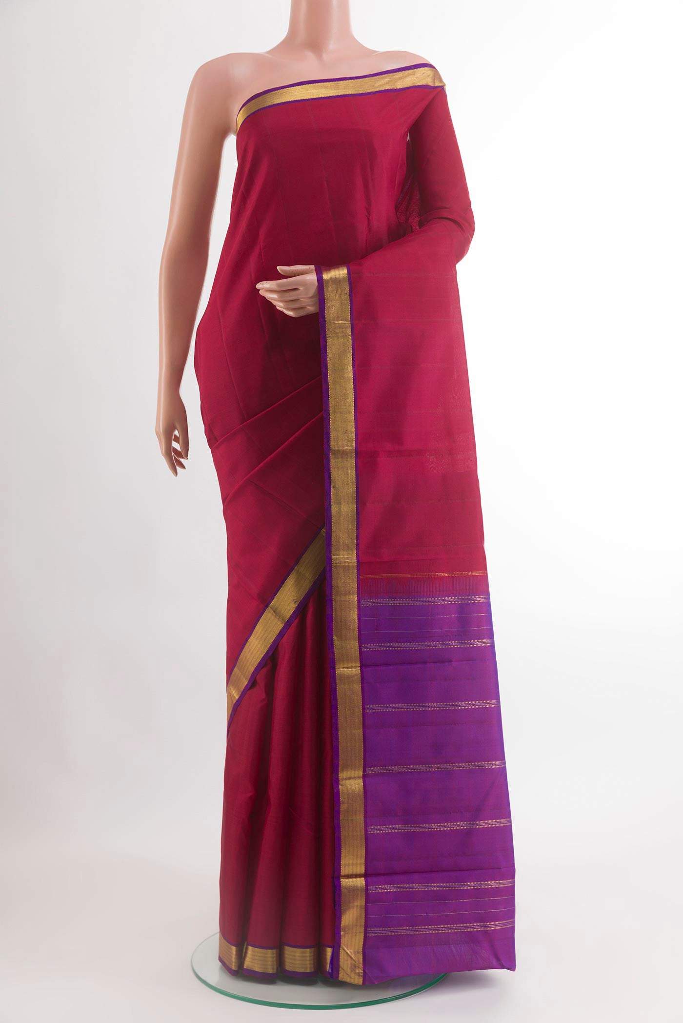 Maroon Kanjivaram Silk Saree with Plain Body and Zari Border.  displayed on a mannequin