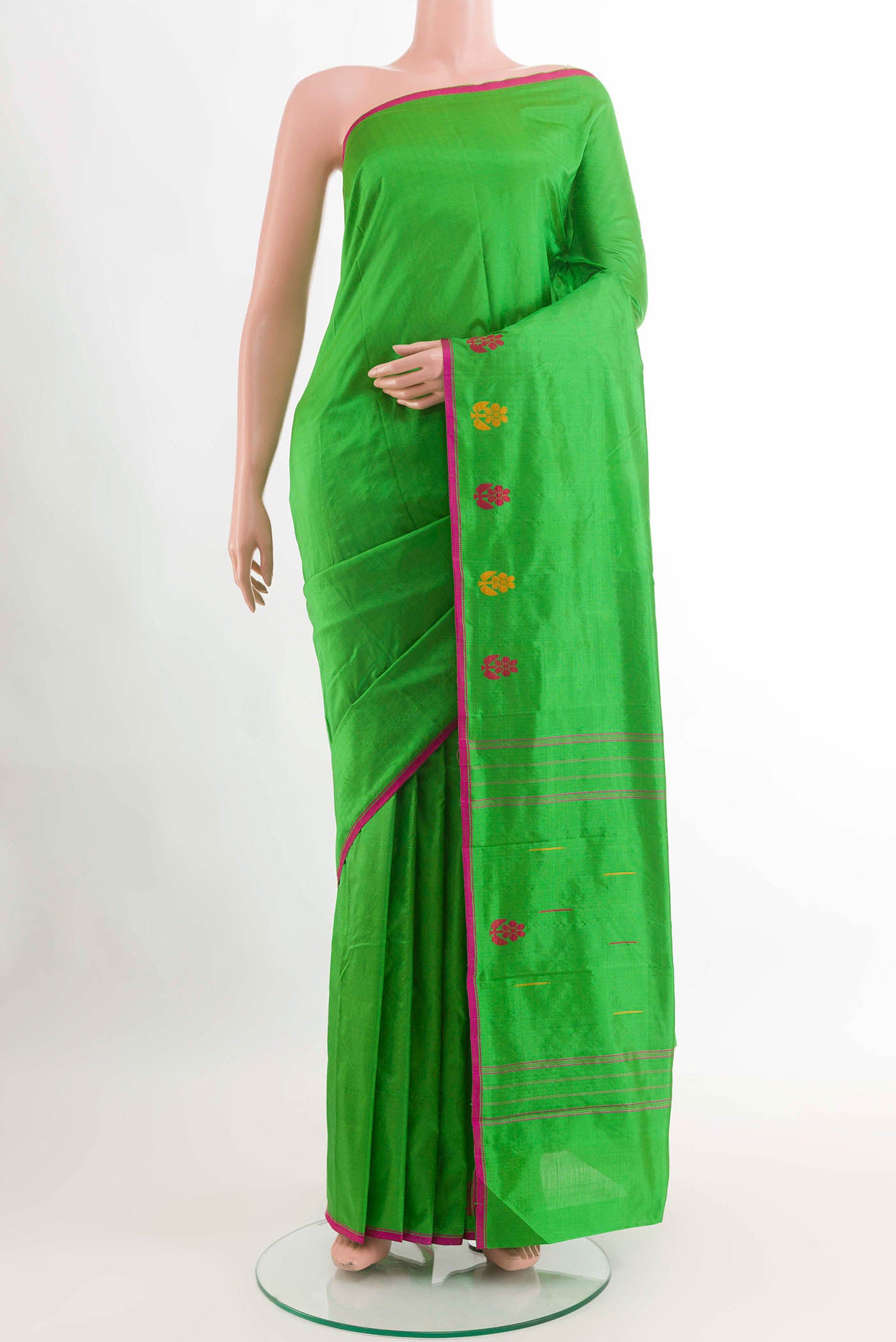 Green Kanchipuram Silk Saree with Plain Body and Thread Border displayed on a mannequin