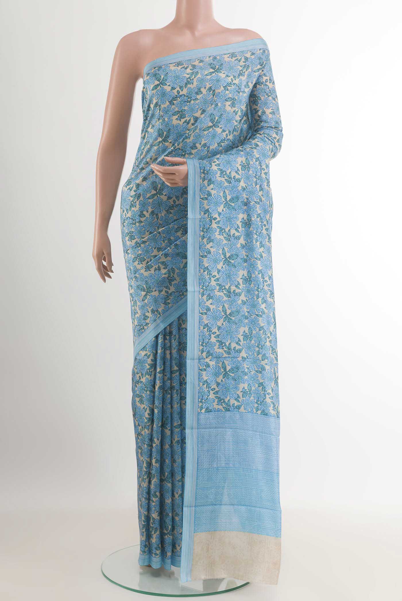 Blue Printed Silk Saree with Printed design on the body and Printed Border.  displayed on a mannequin