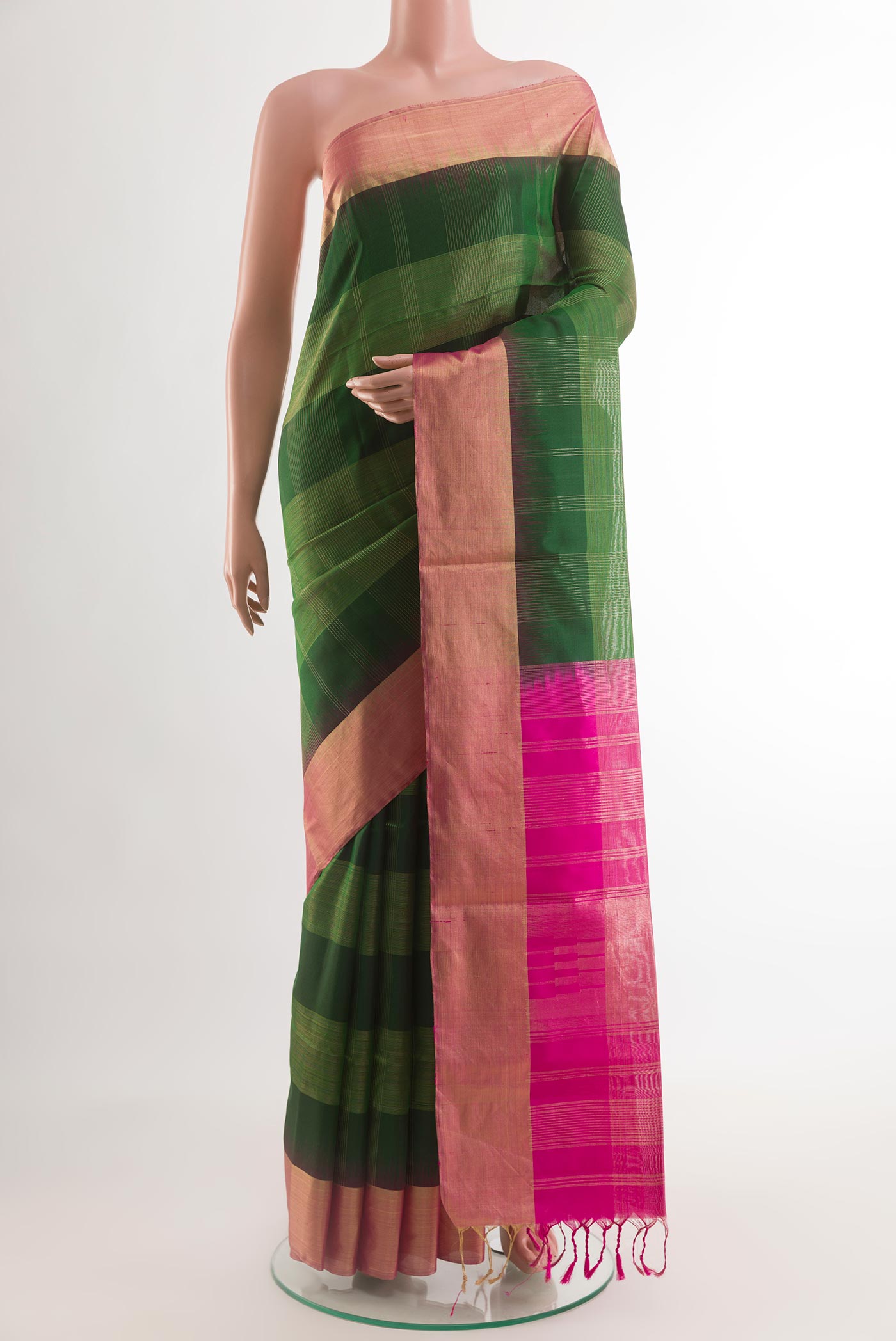 Bottle Green Soft Silk Saree with Zari Butta on the body and Zari Border.  displayed on a mannequin
