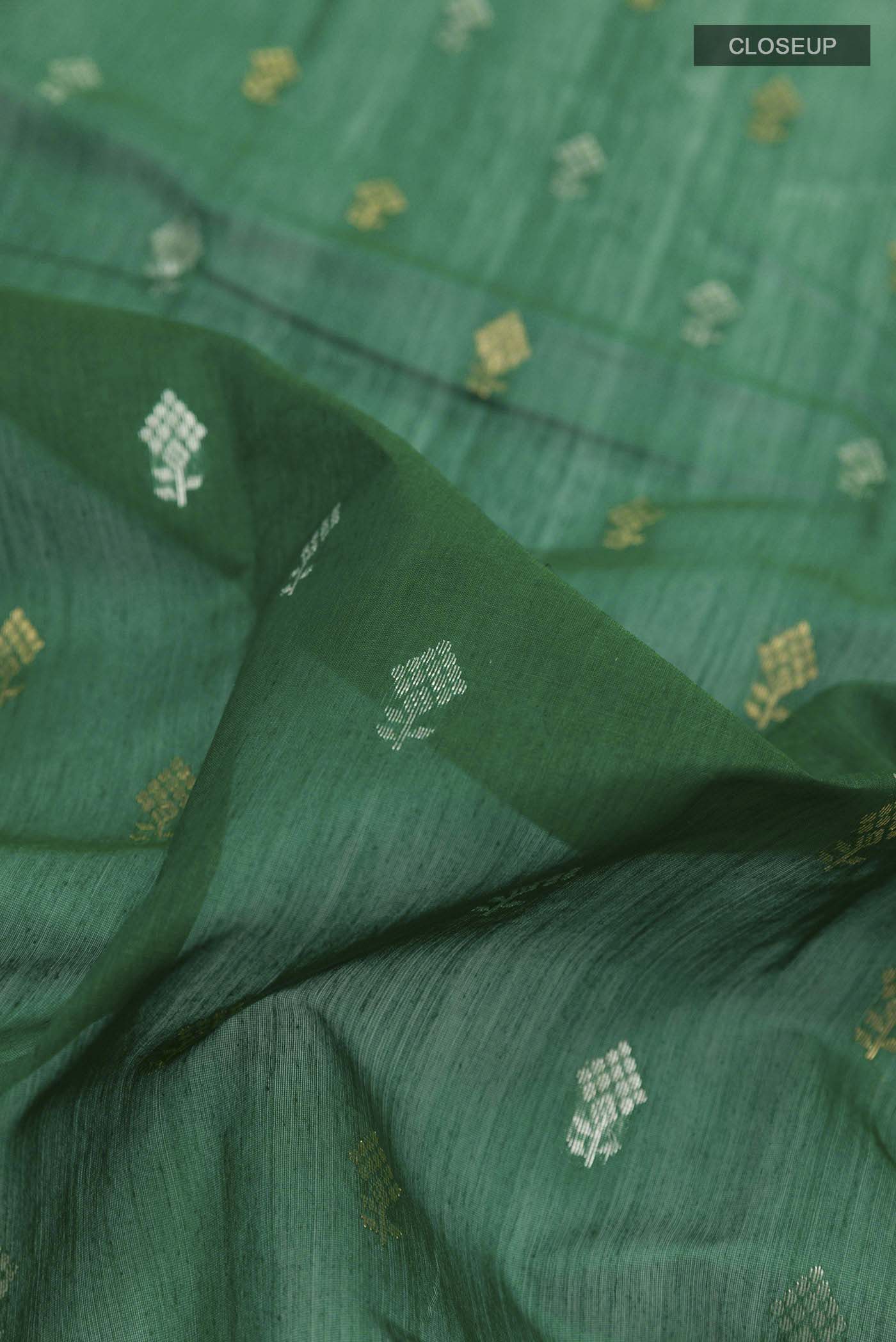 Close up of Green Chanderi Silk Cotton Saree with Zari Butta on the body and Zari Border displaying folds