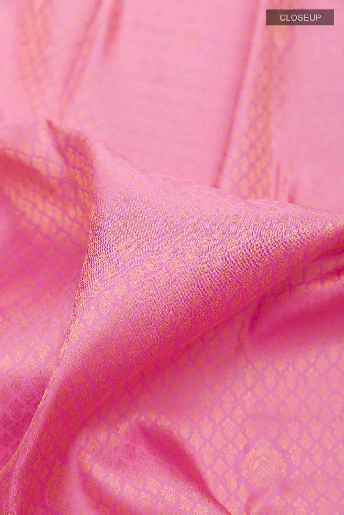 Close up of Pure Silk Pure Zari Pink Kanchipuram Saree with Zari Brocade on the body and Zari Border displaying folds