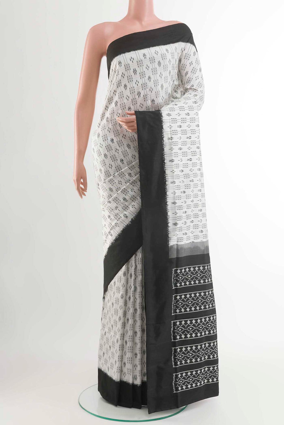 White Pochampally Silk Saree with Pure Ikat on the body and Plain Border displayed on a mannequin