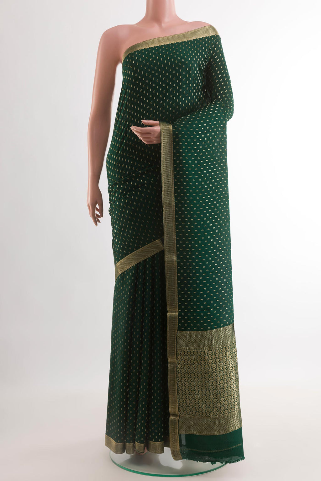 Bottle Green Mysore Crepe Saree with Zari Butta on the body and Zari Border.  displayed on a mannequin