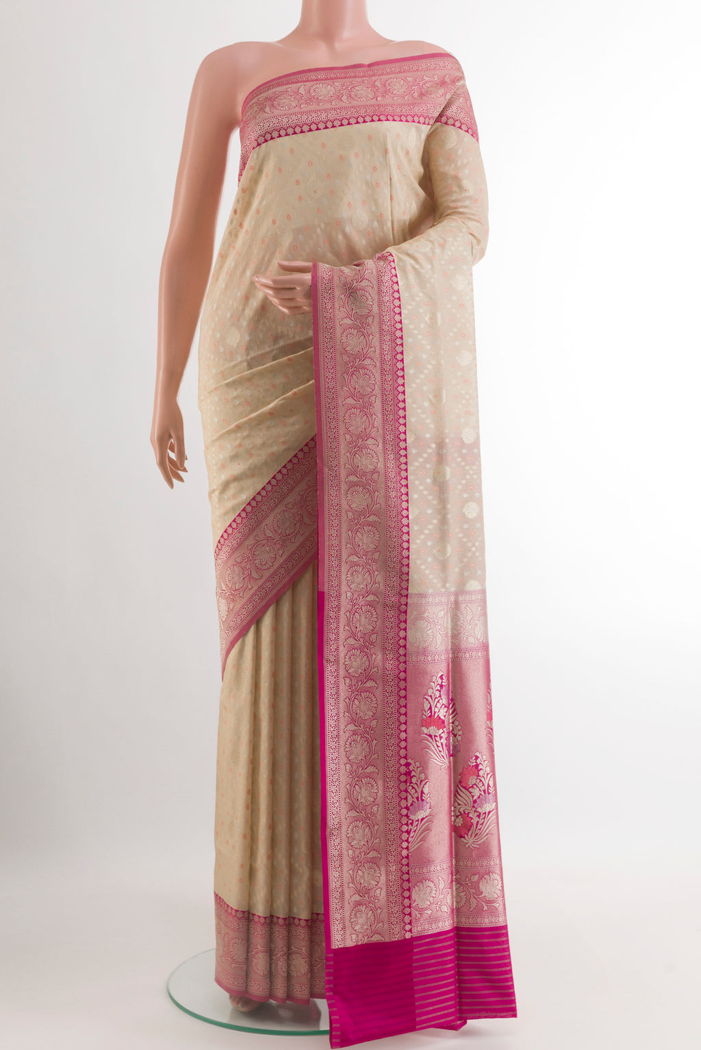 Cream Banarasi Silk Saree with Zari Butta on the body and Zari Border.  displayed on a mannequin
