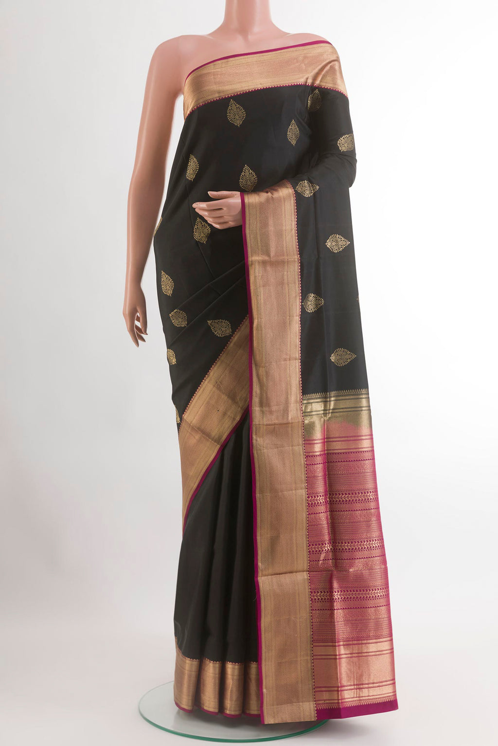 Black Soft Silk Saree with Zari Butta on the body and Zari Border.  displayed on a mannequin