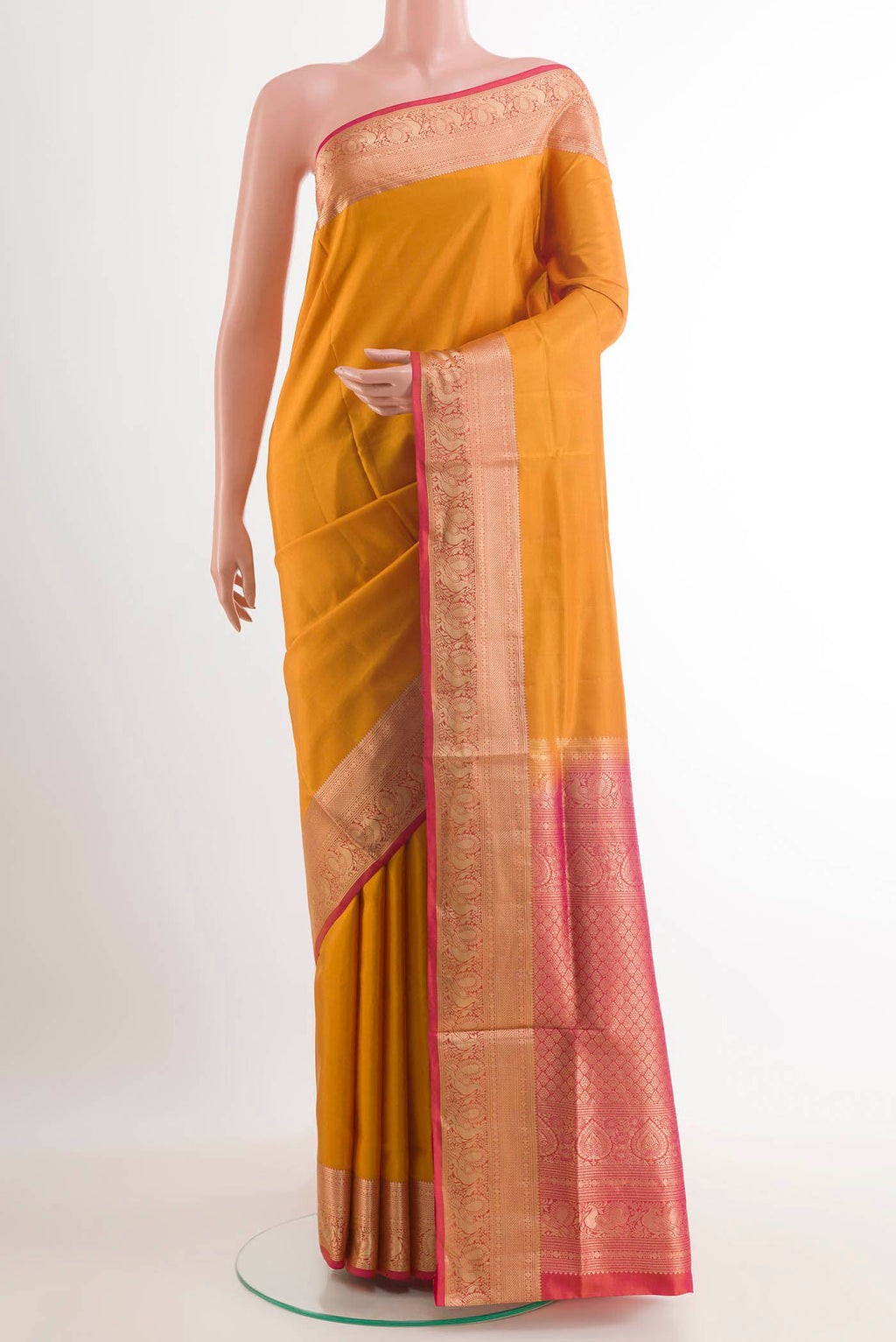 Yellow Soft Silk Saree with Plain Body and Zari Border.  displayed on a mannequin