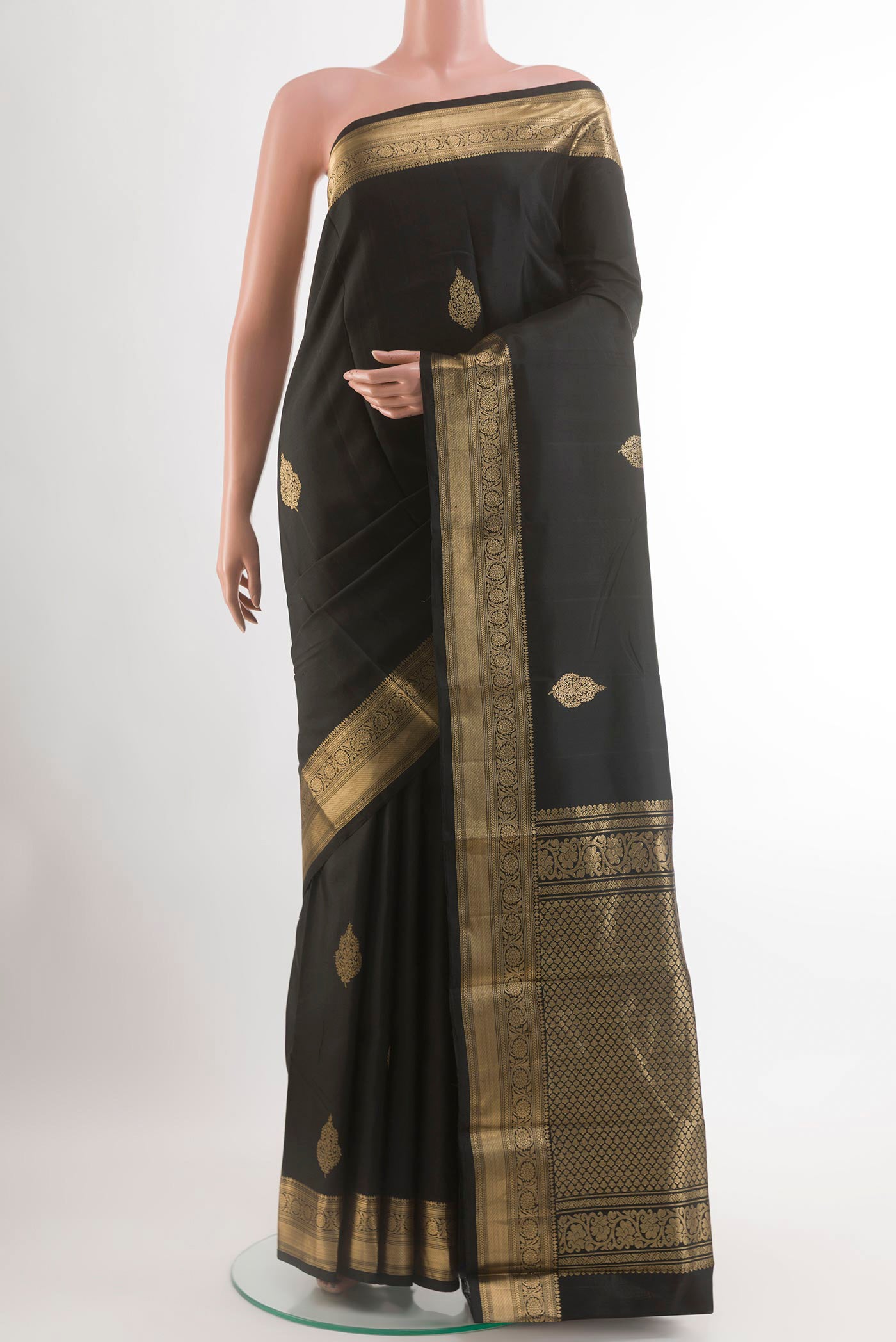 Black Kanjivaram Silk Saree with Zari Butta on the body and Zari Border.  displayed on a mannequin