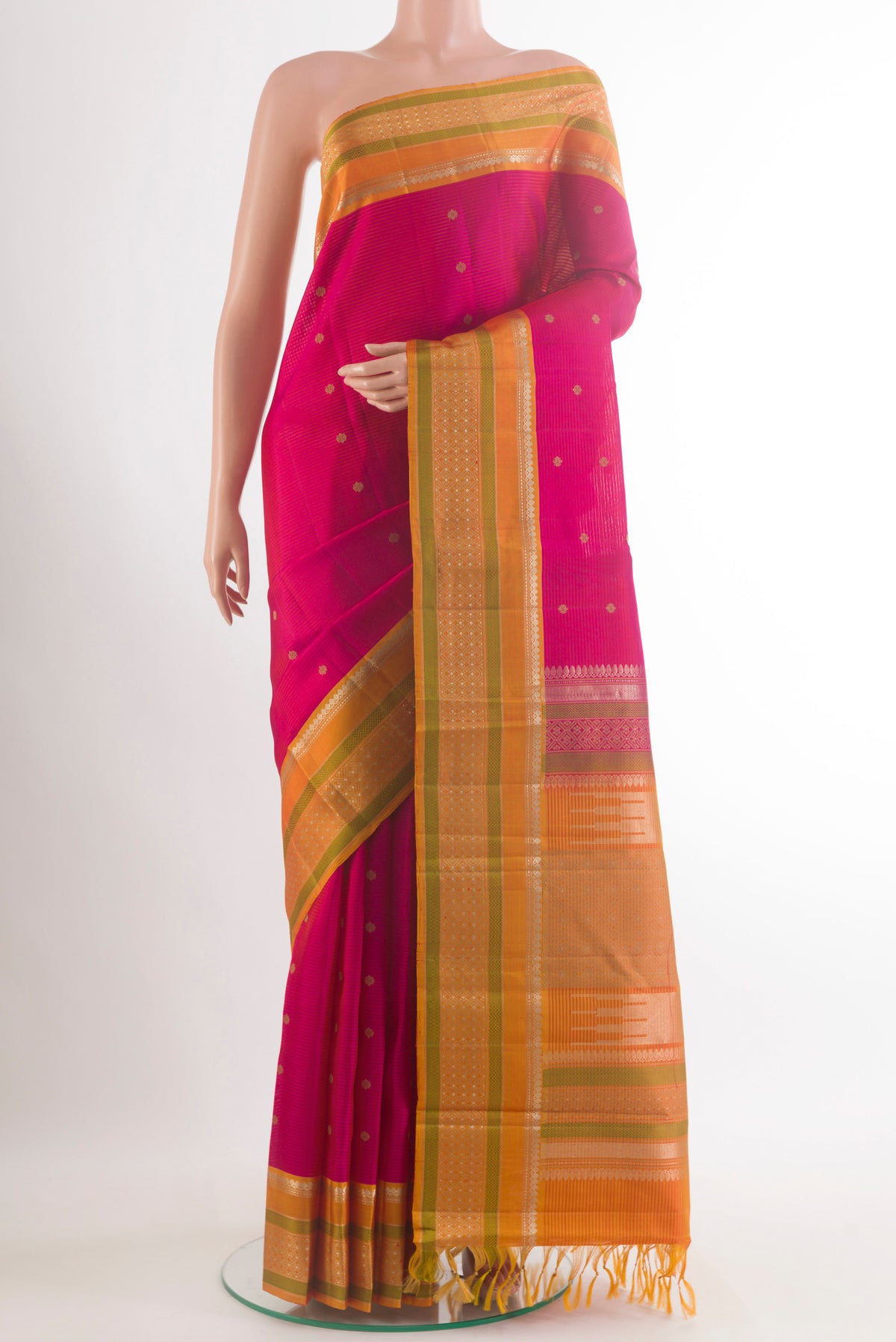 Pure Silk Pink Kanchipuram Saree with Zari Butta on the body and Zari Border.  displayed on a mannequin