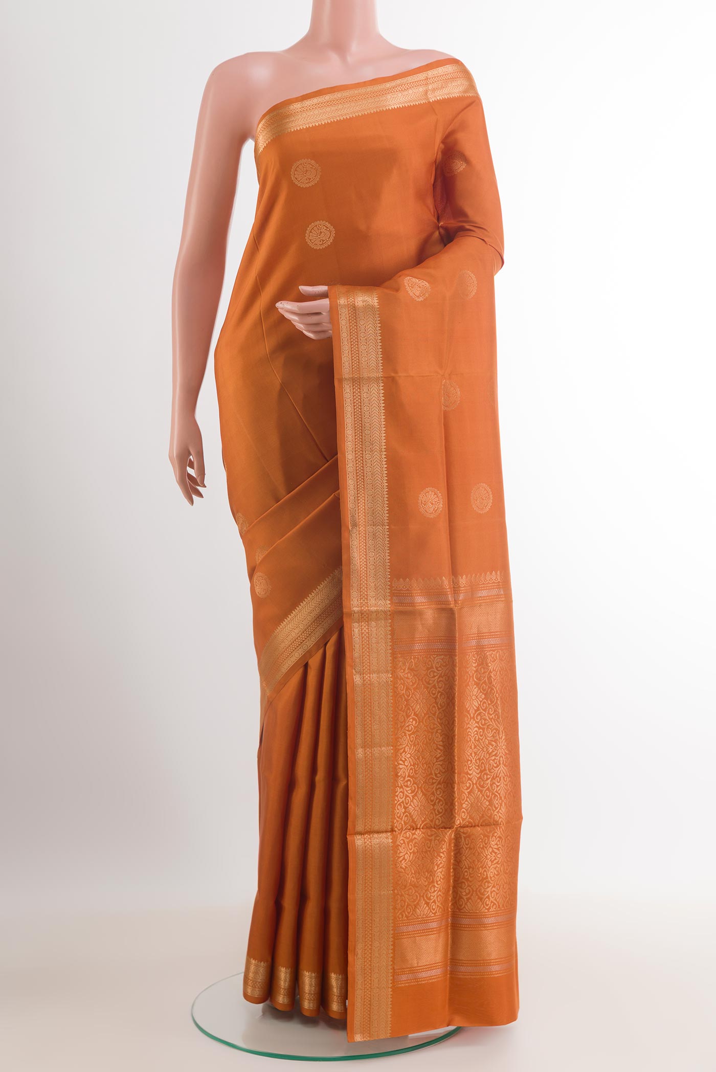 Mustard Soft Silk Saree with Zari Butta on the body and Zari Border.  displayed on a mannequin