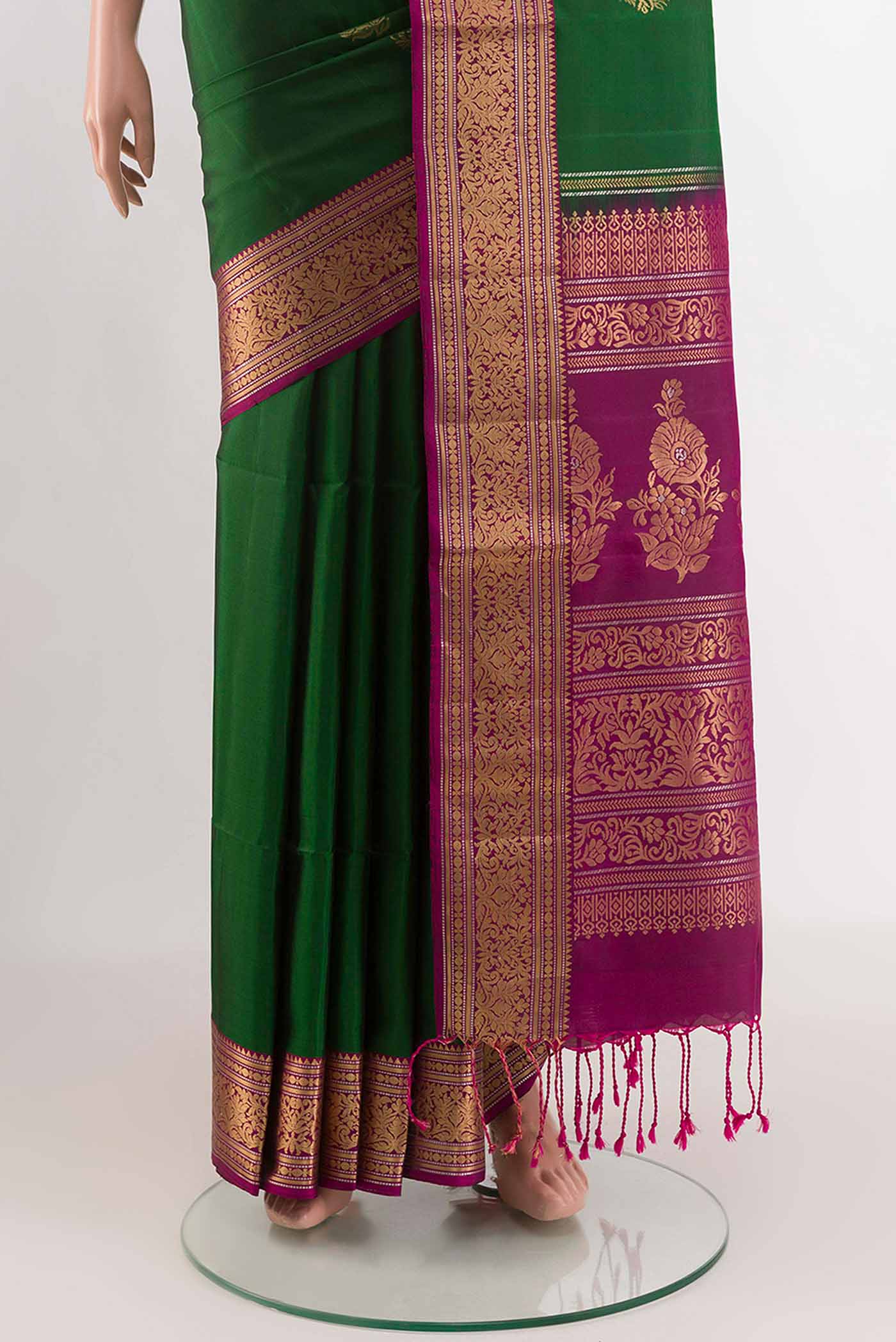 Pleats and pallu of Green Soft Silk Saree with Zari Butta on the body and Zari Border