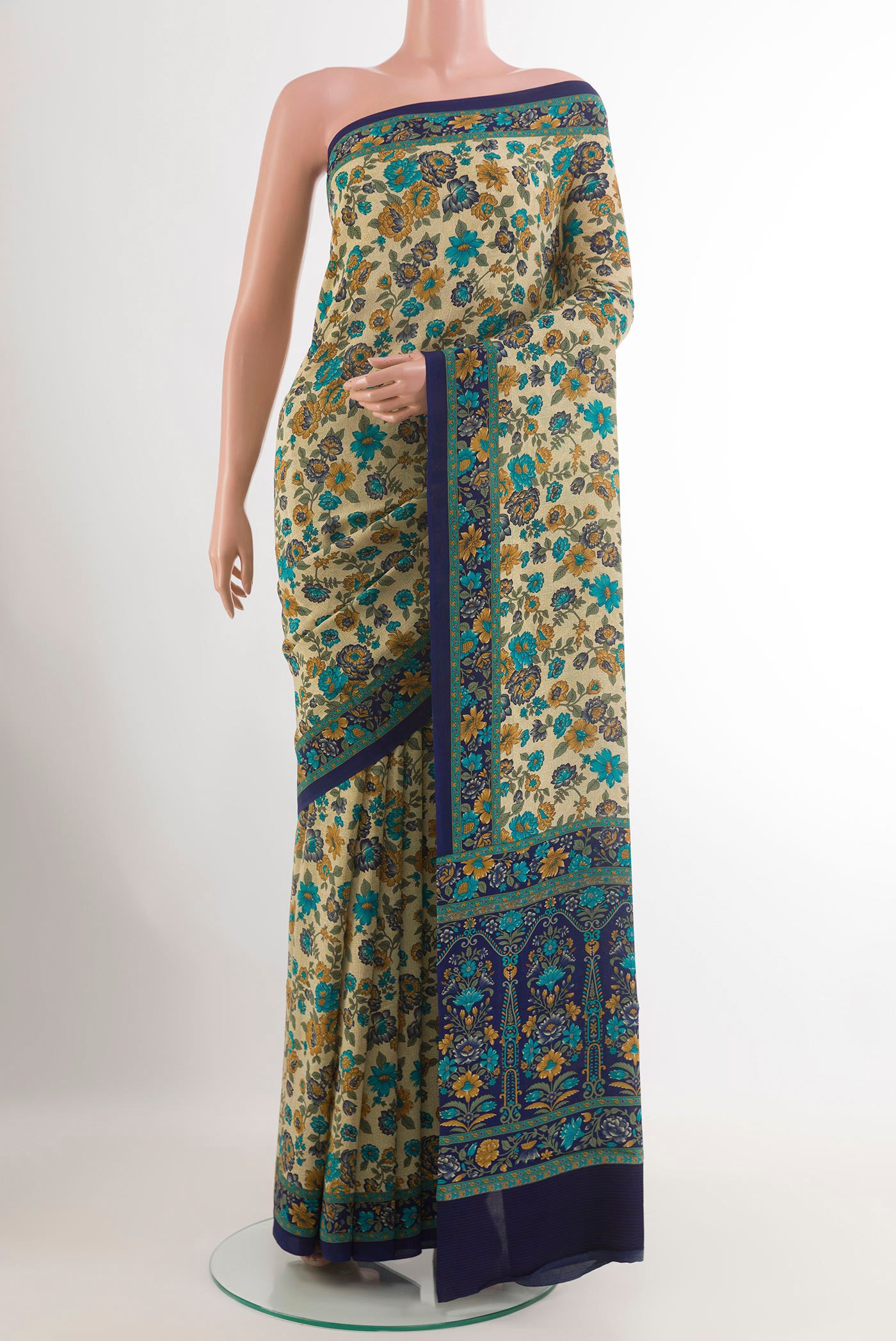 Beige Crepe Saree with Printed design on the body and Plain Border.  displayed on a mannequin