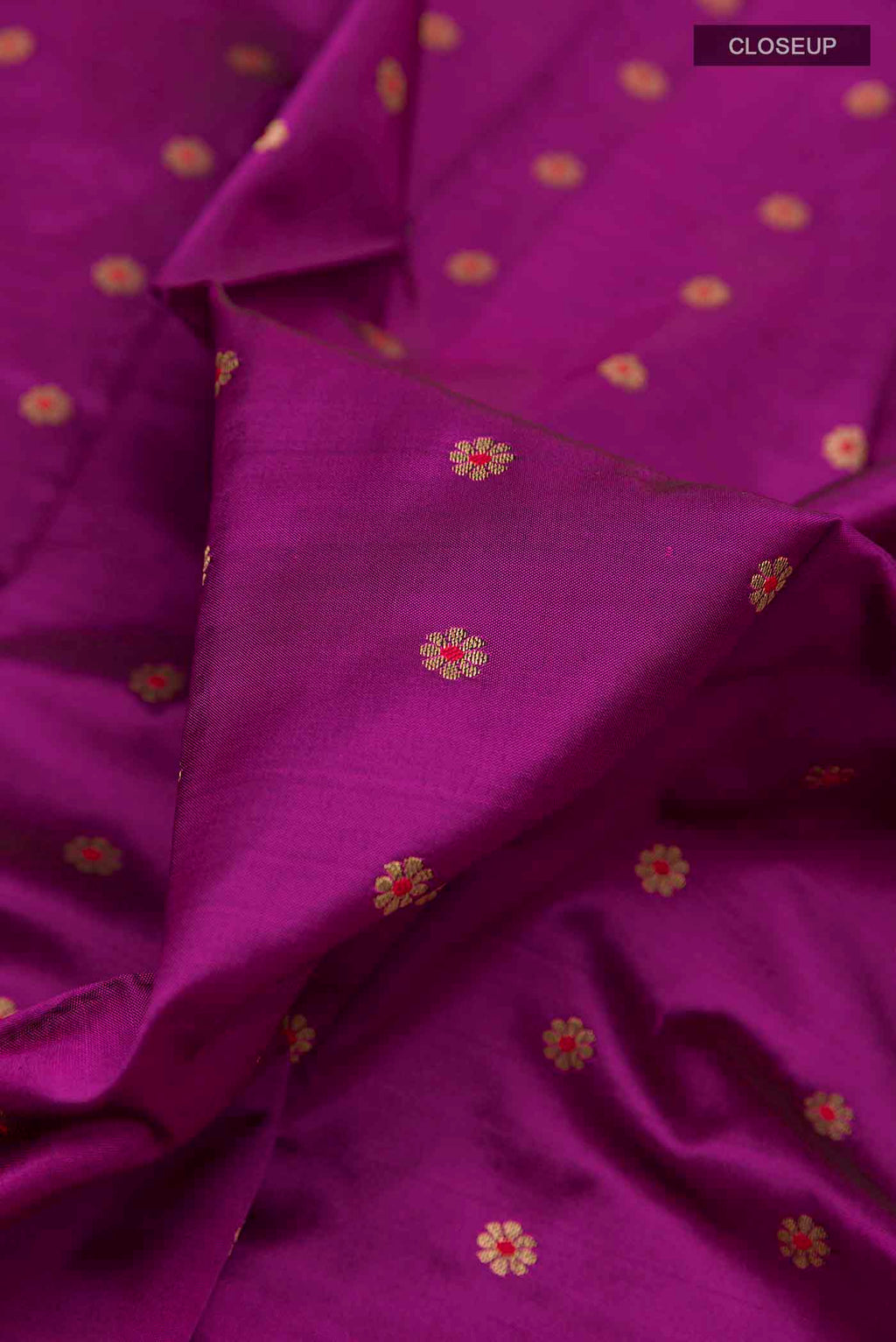 Close up of Purple Paithani Silk Saree with Zari Butta on the body and Zari Border displaying folds