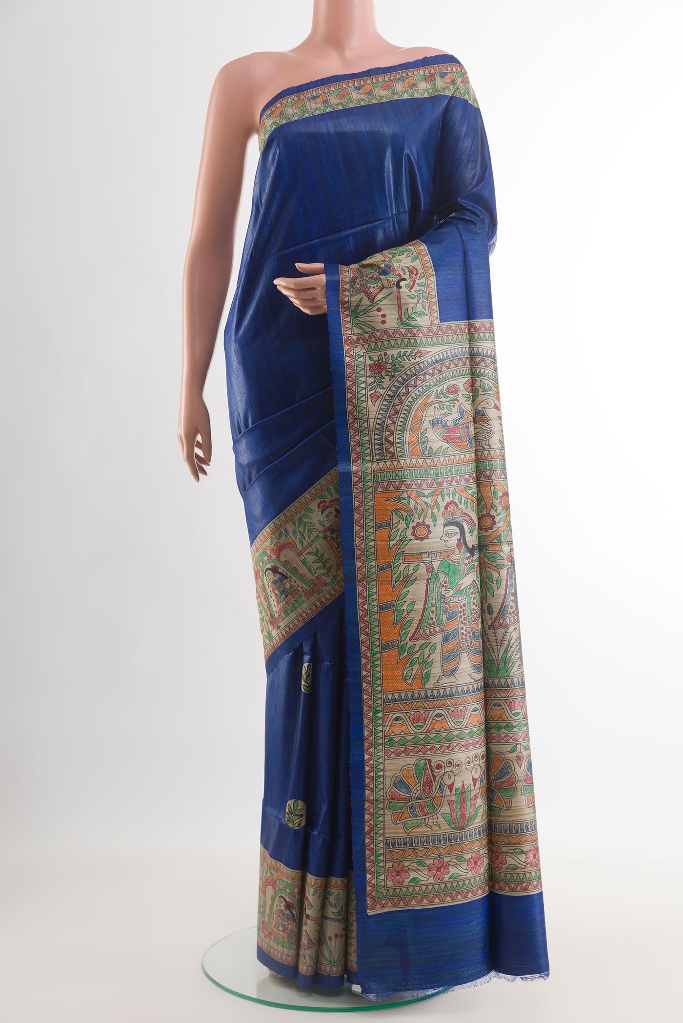 Royal Blue Tussar Silk Saree with Printed design on the body and Printed Border.  displayed on a mannequin