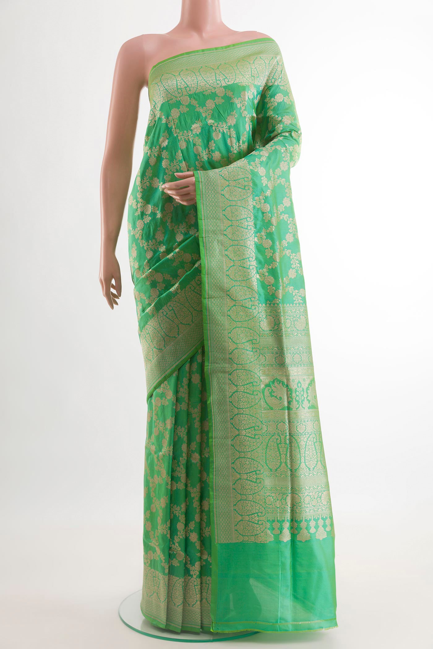 Green Banarasi Silk Saree with Zari Brocade on the body and Zari Border.  displayed on a mannequin