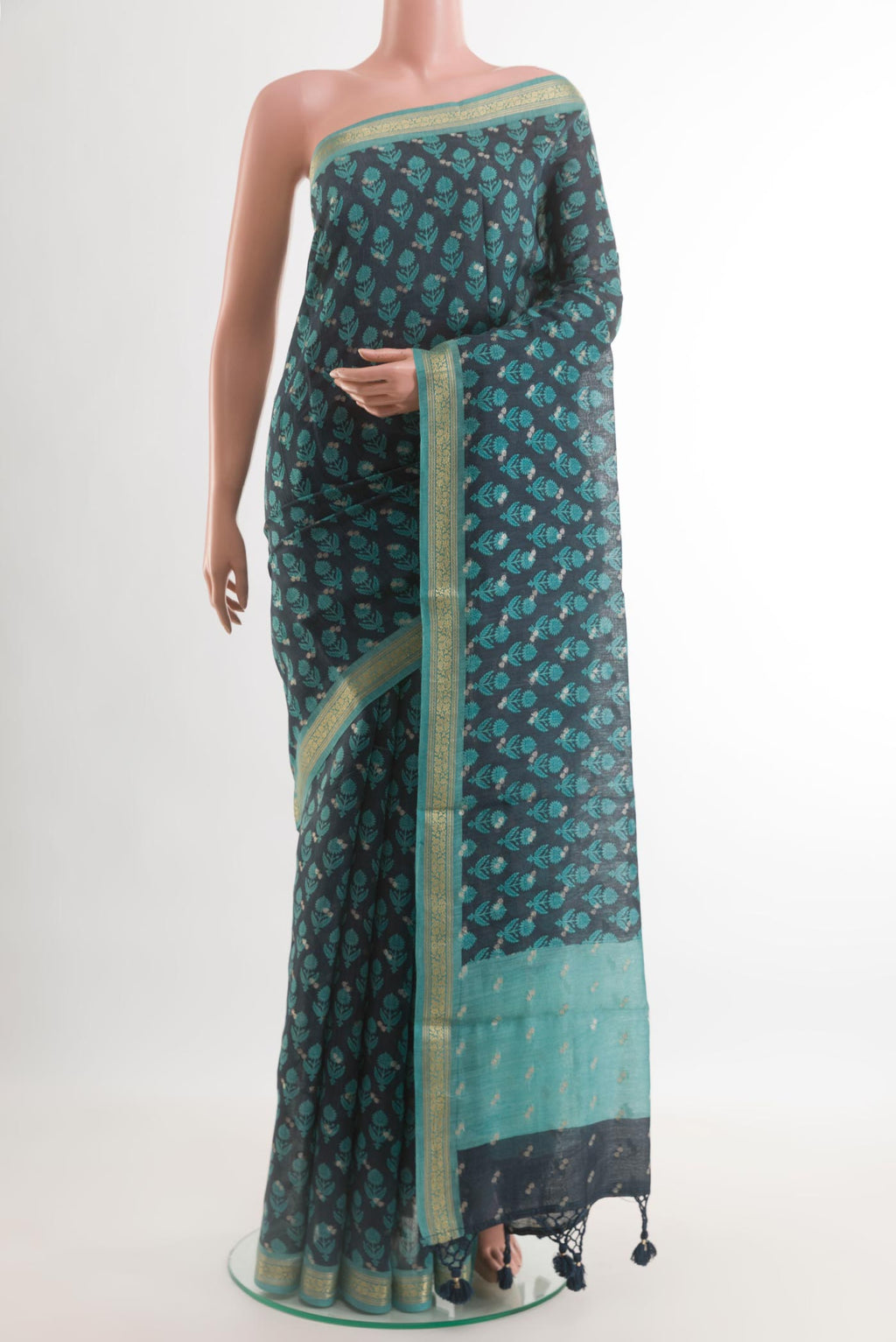 Navy Blue Tussar Silk Saree with Printed design on the body and Zari Border.  displayed on a mannequin