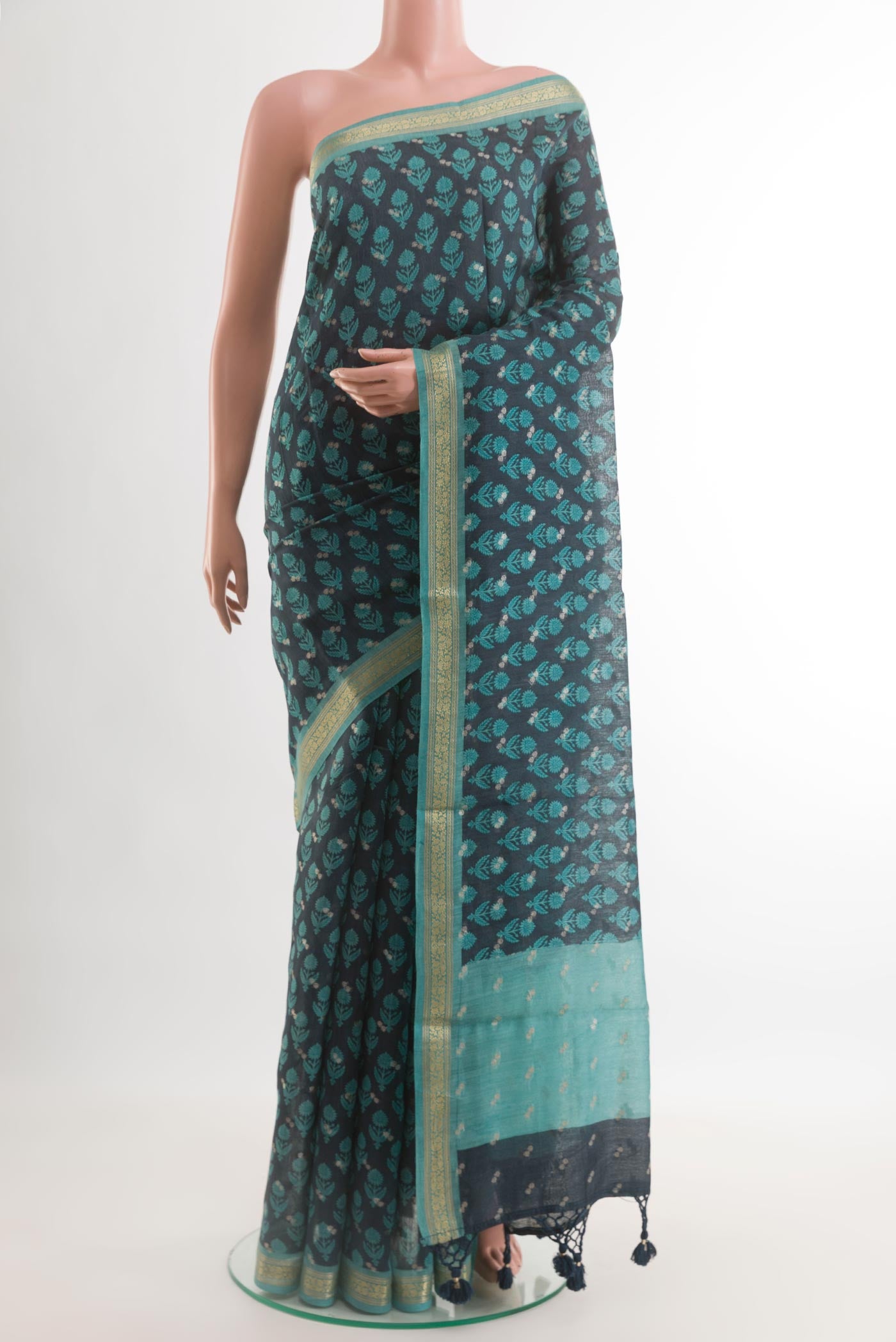 Navy Blue Tussar Silk Saree with Printed design on the body and Zari Border.  displayed on a mannequin