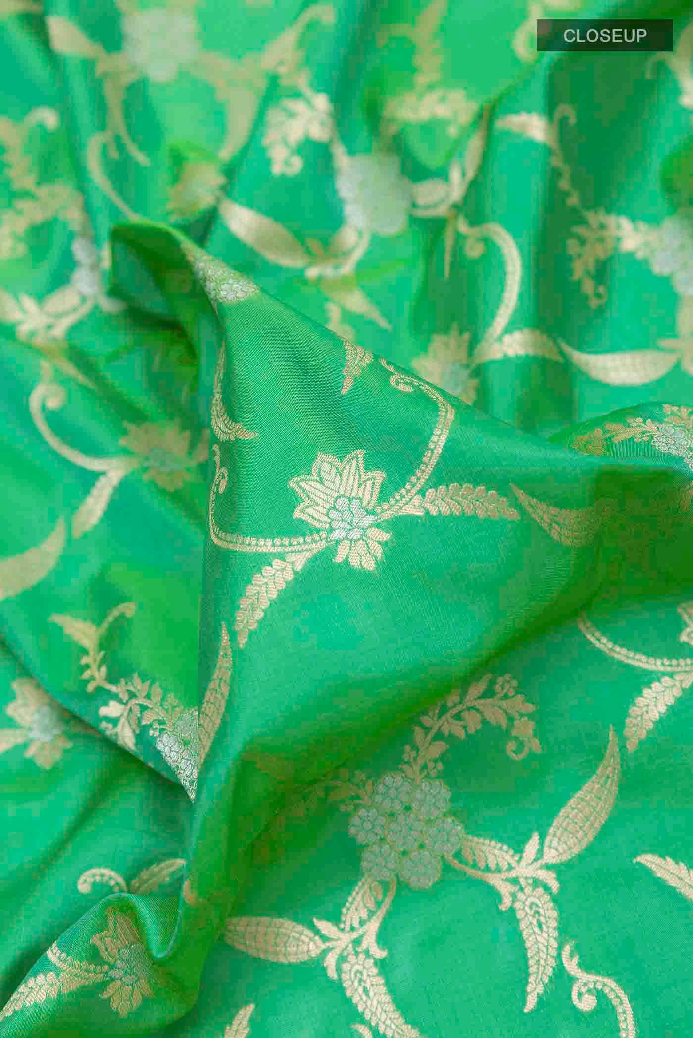 Close up of Green Banarasi Silk Saree with Zari Brocade on the body and Zari Border displaying folds