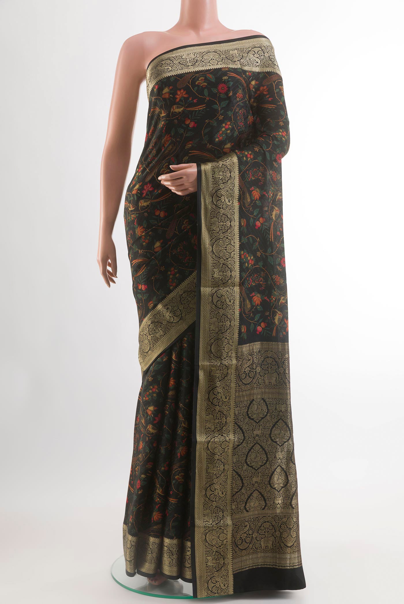 Black Crepe Saree with Printed design on the body and Zari Border.  displayed on a mannequin