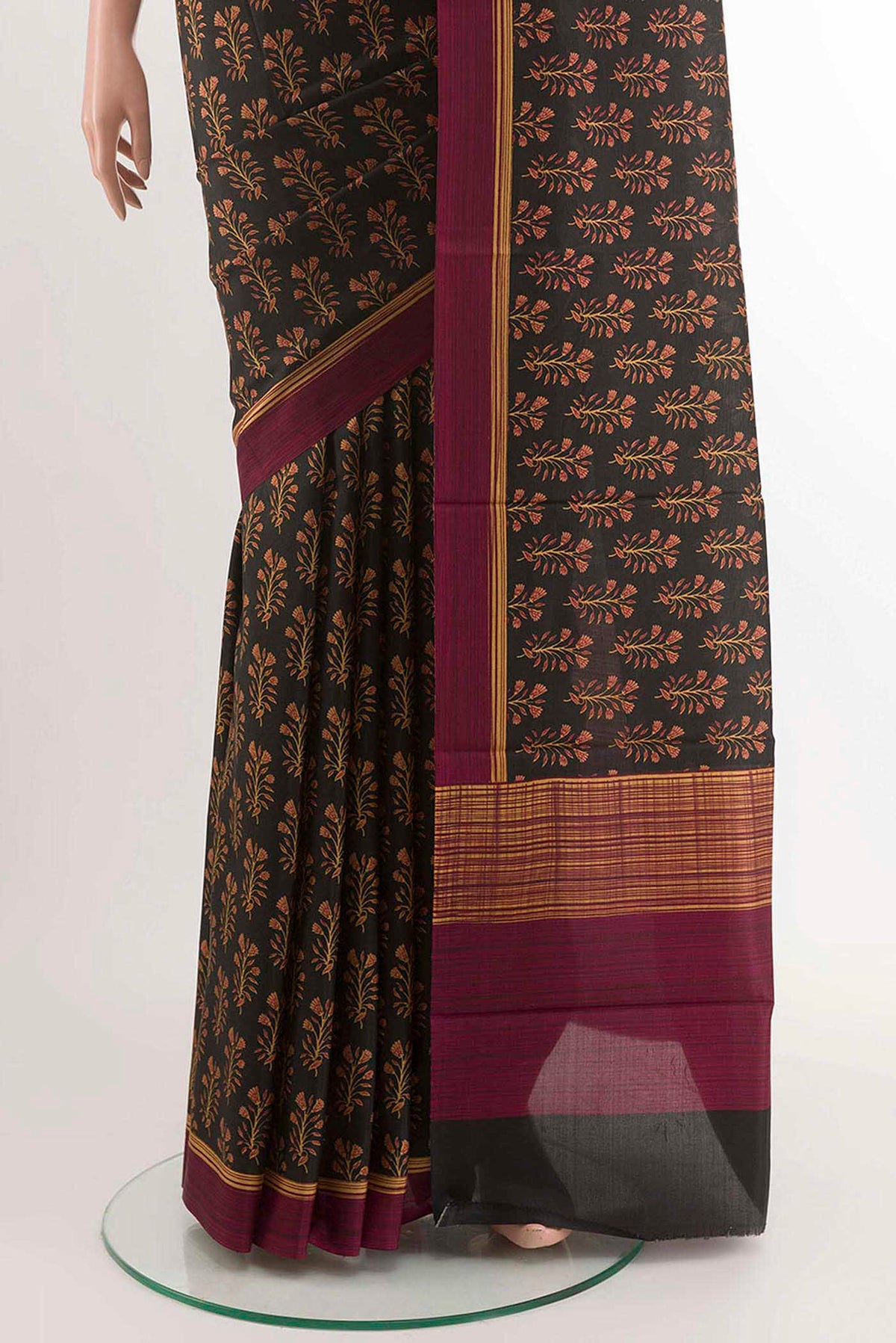 Pleats and pallu of Black Printed Silk Saree With Printed design on the body and Printed Border