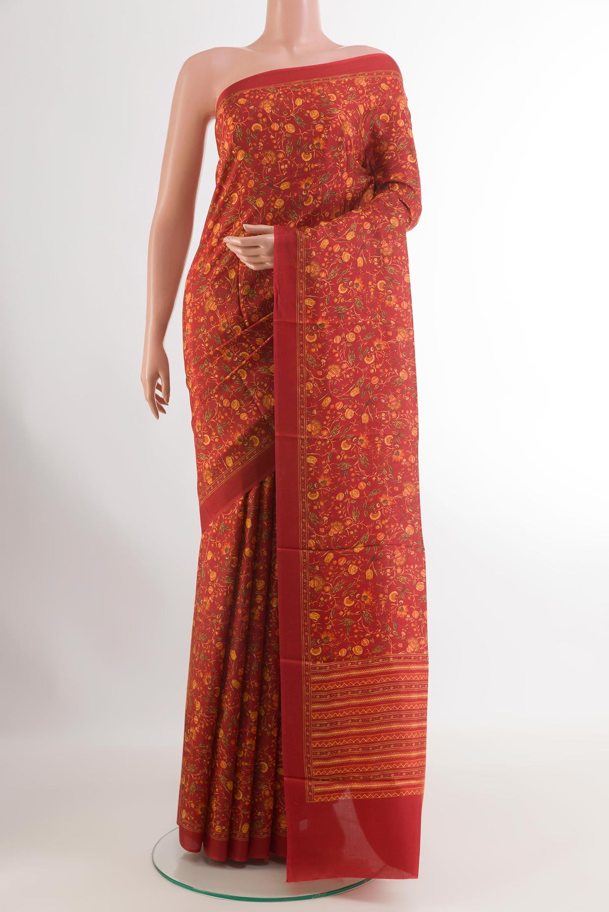 Red Printed Silk Saree with Printed design on the body and Printed Border.  displayed on a mannequin