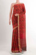 Red Crepe Saree With Printed design on the body and Zari Border displayed on a mannequin