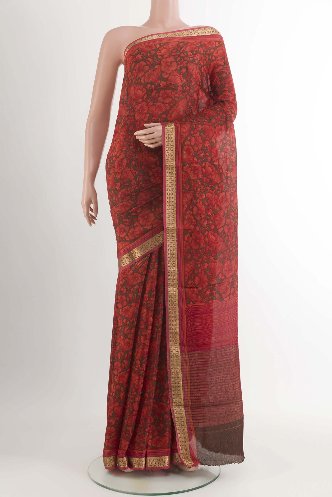 Red Crepe Saree With Printed design on the body and Zari Border displayed on a mannequin