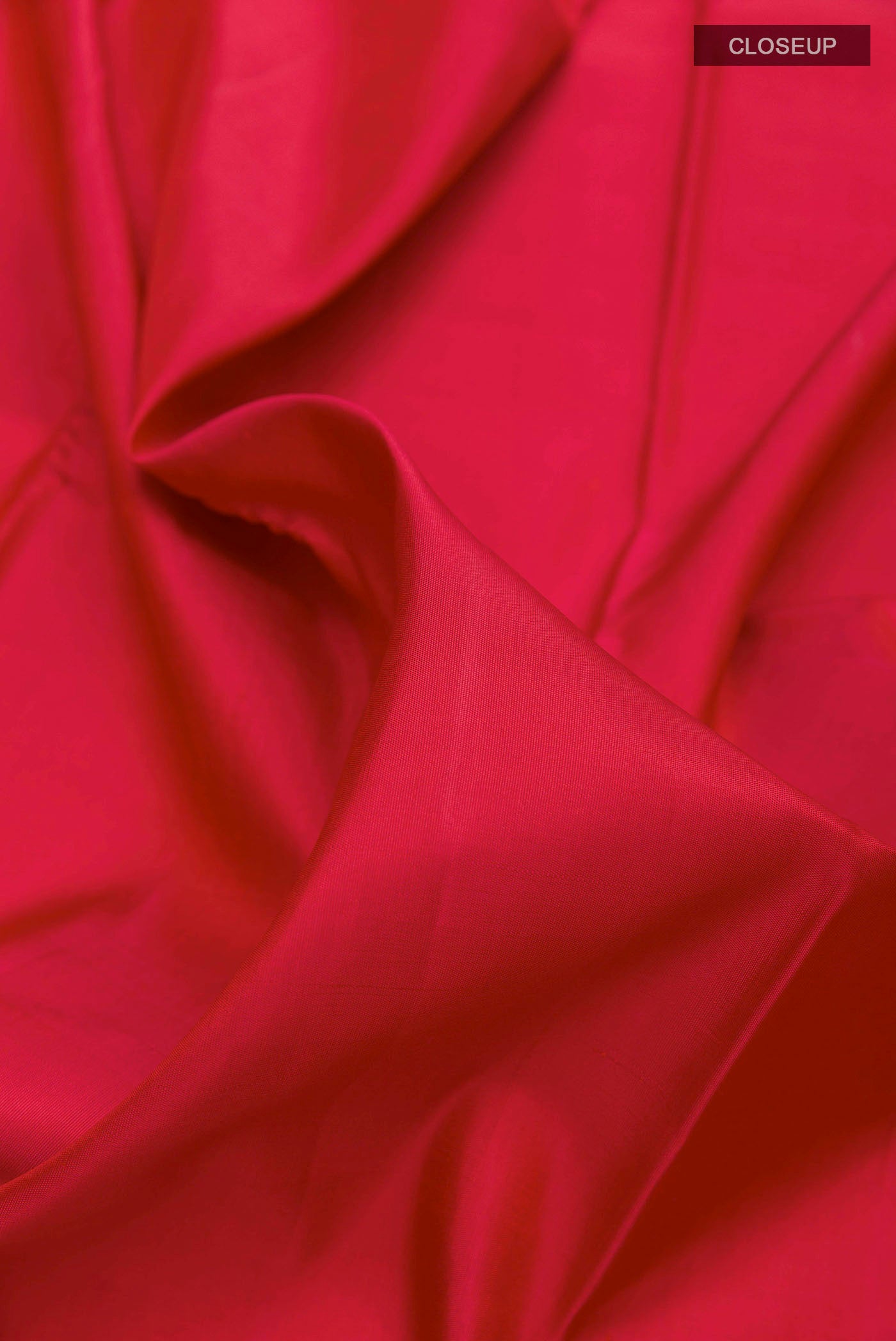 Close up of Maroon Kanchipuram Silk Saree with Plain Body and Rising Temple Border displaying folds