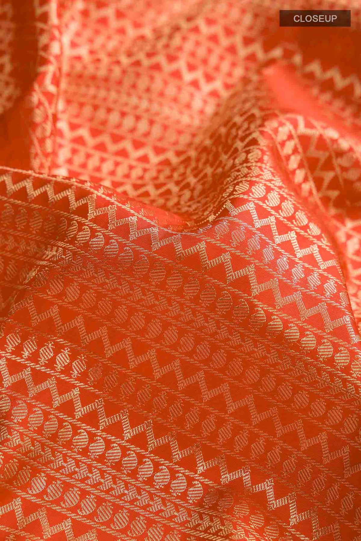 Close up of Red Soft Silk Saree with Stripes on the body and Zari Border displaying folds